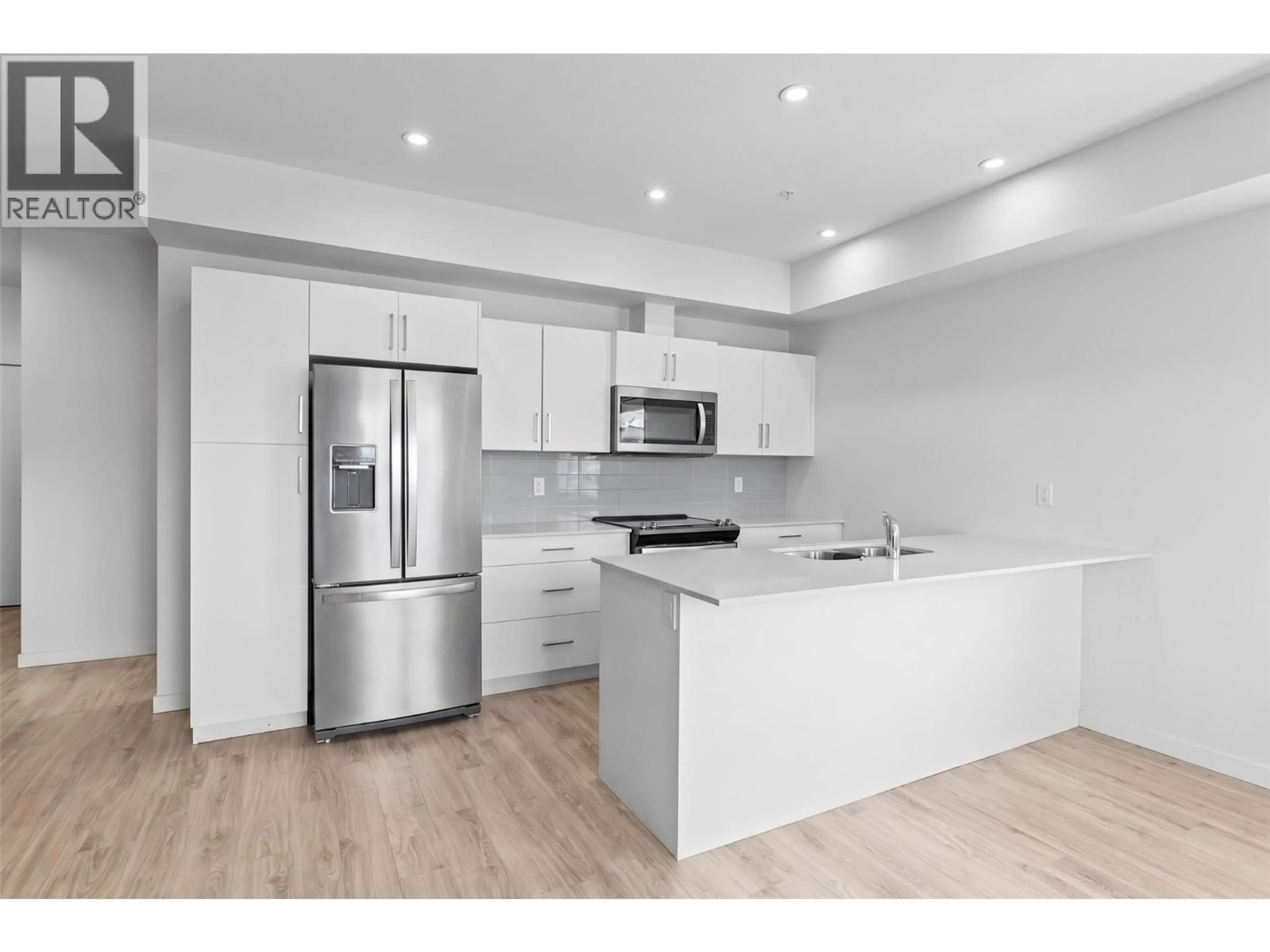 Open concept kitchen, wood/laminate floor for 415 - 2345 BUTT ROAD, West Kelowna British Columbia V4T1N6