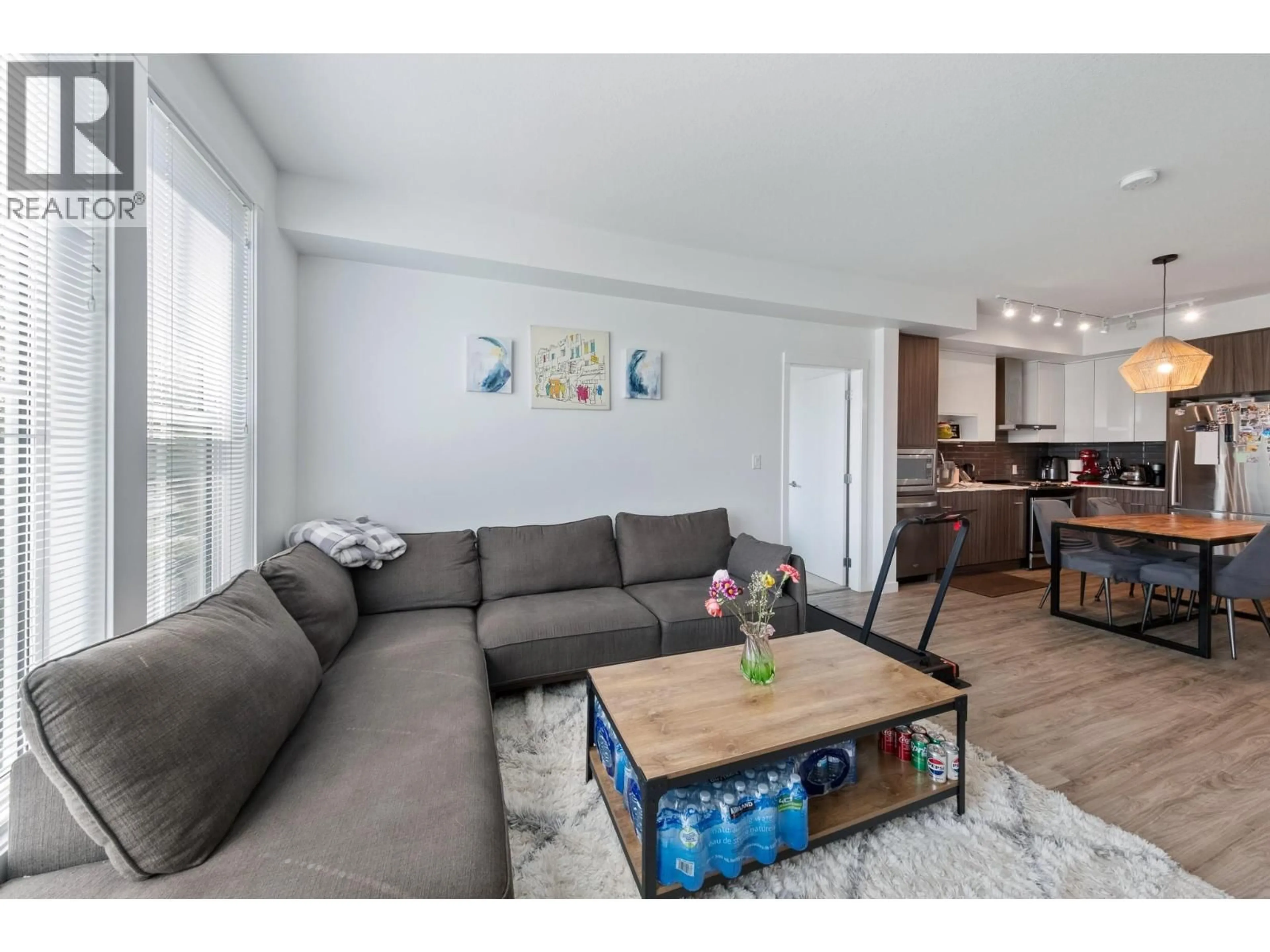 Living room with furniture, wood/laminate floor for 223 - 1775 CHAPMAN PLACE, Kelowna British Columbia V1Y0G3