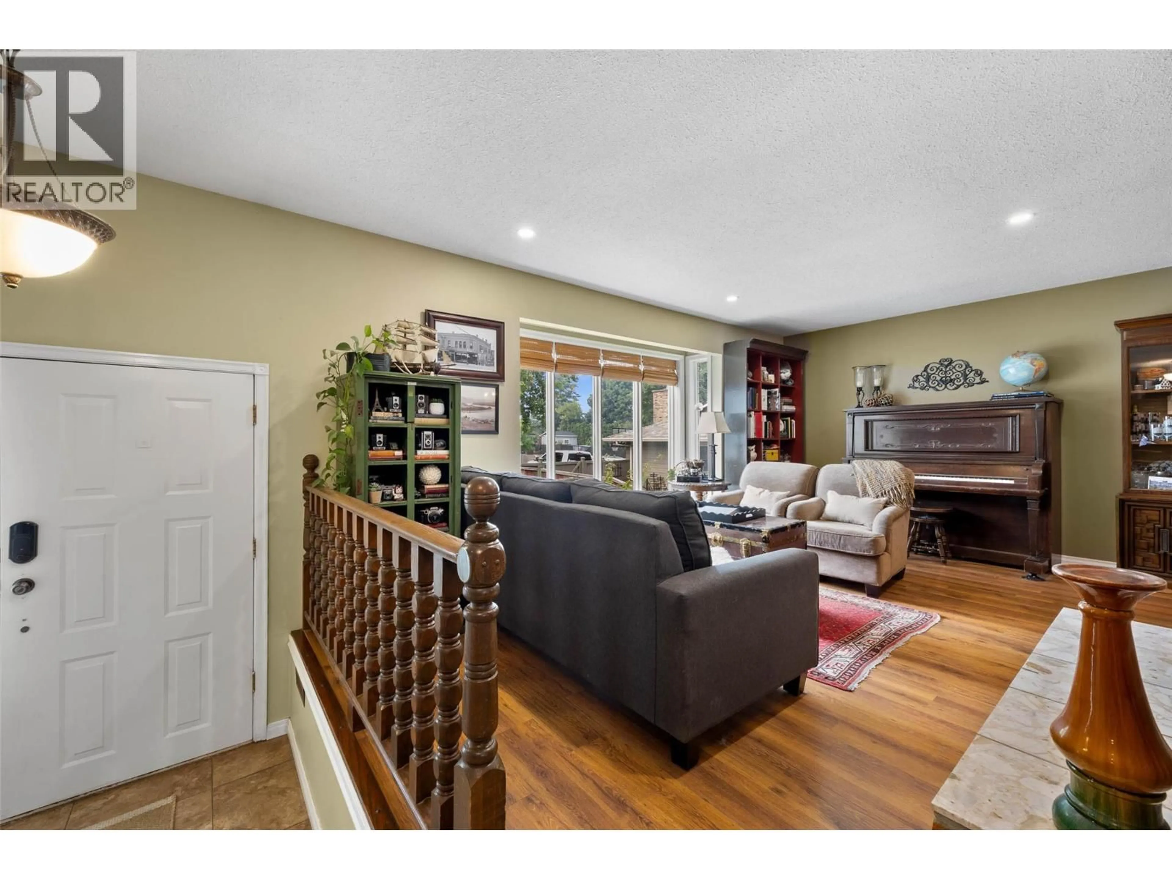 Living room with furniture, wood/laminate floor for 2269 BALFOUR COURT, Kamloops British Columbia V1S1H5