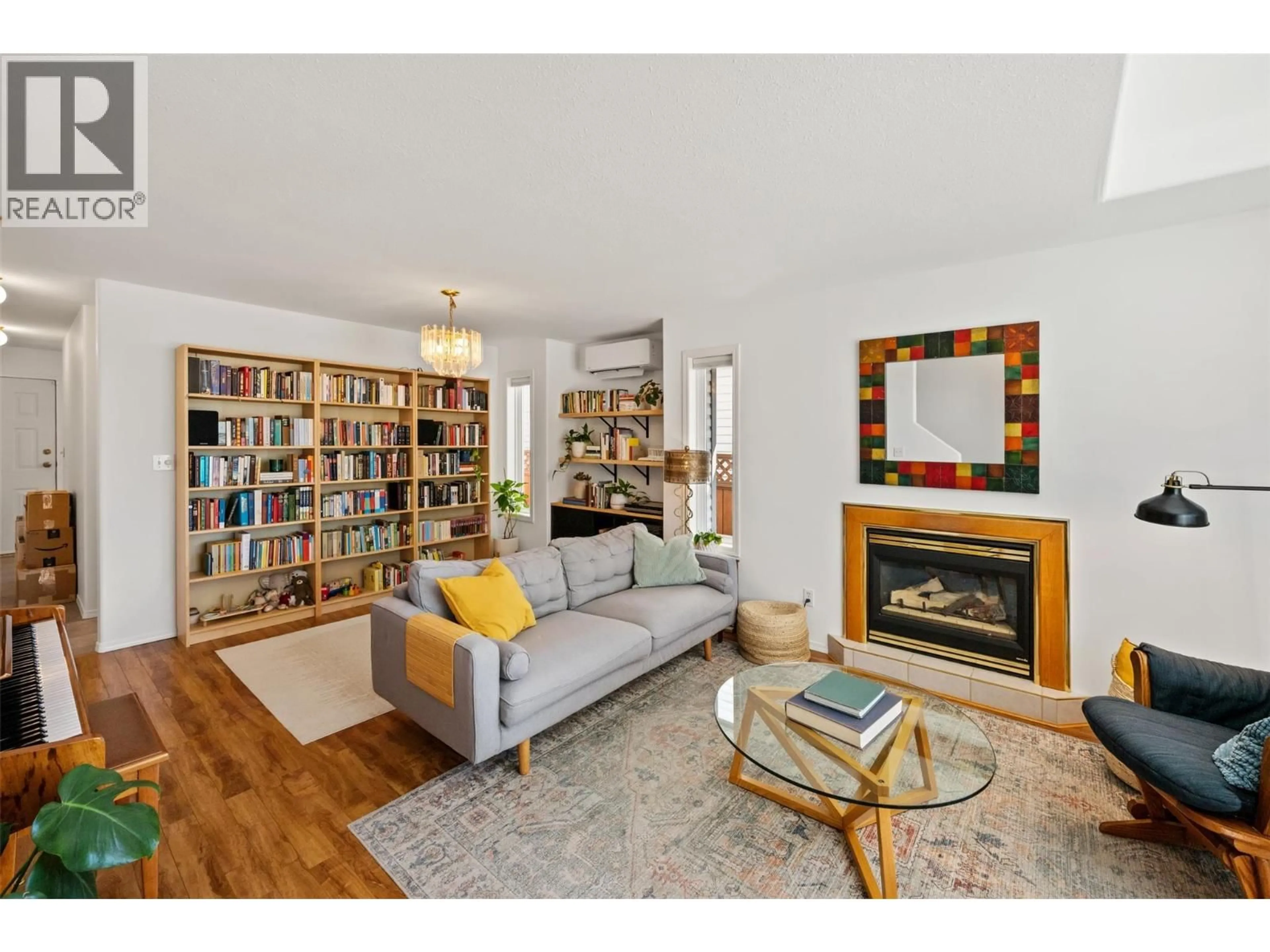 Living room with furniture, wood/laminate floor for 102 - 626 VAN HORNE STREET, Penticton British Columbia V2A4L1