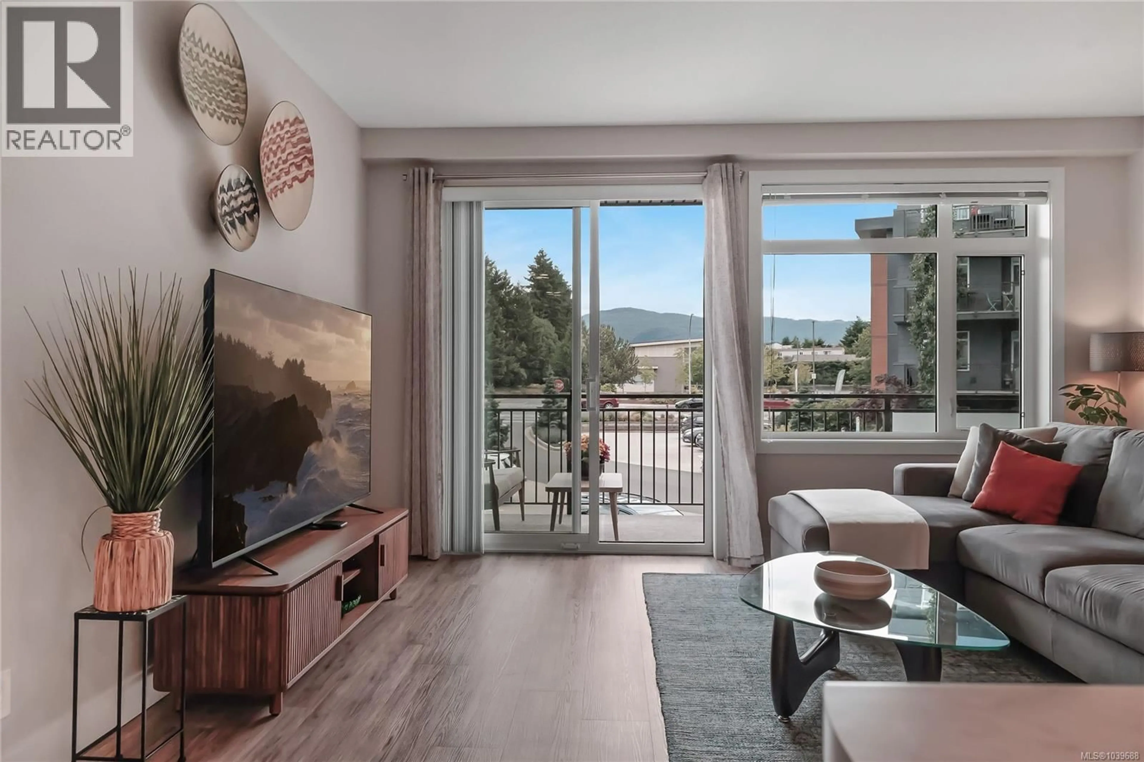 Living room with furniture, wood/laminate floor for 201 - 6544 METRAL DRIVE, Nanaimo British Columbia V9T2L8