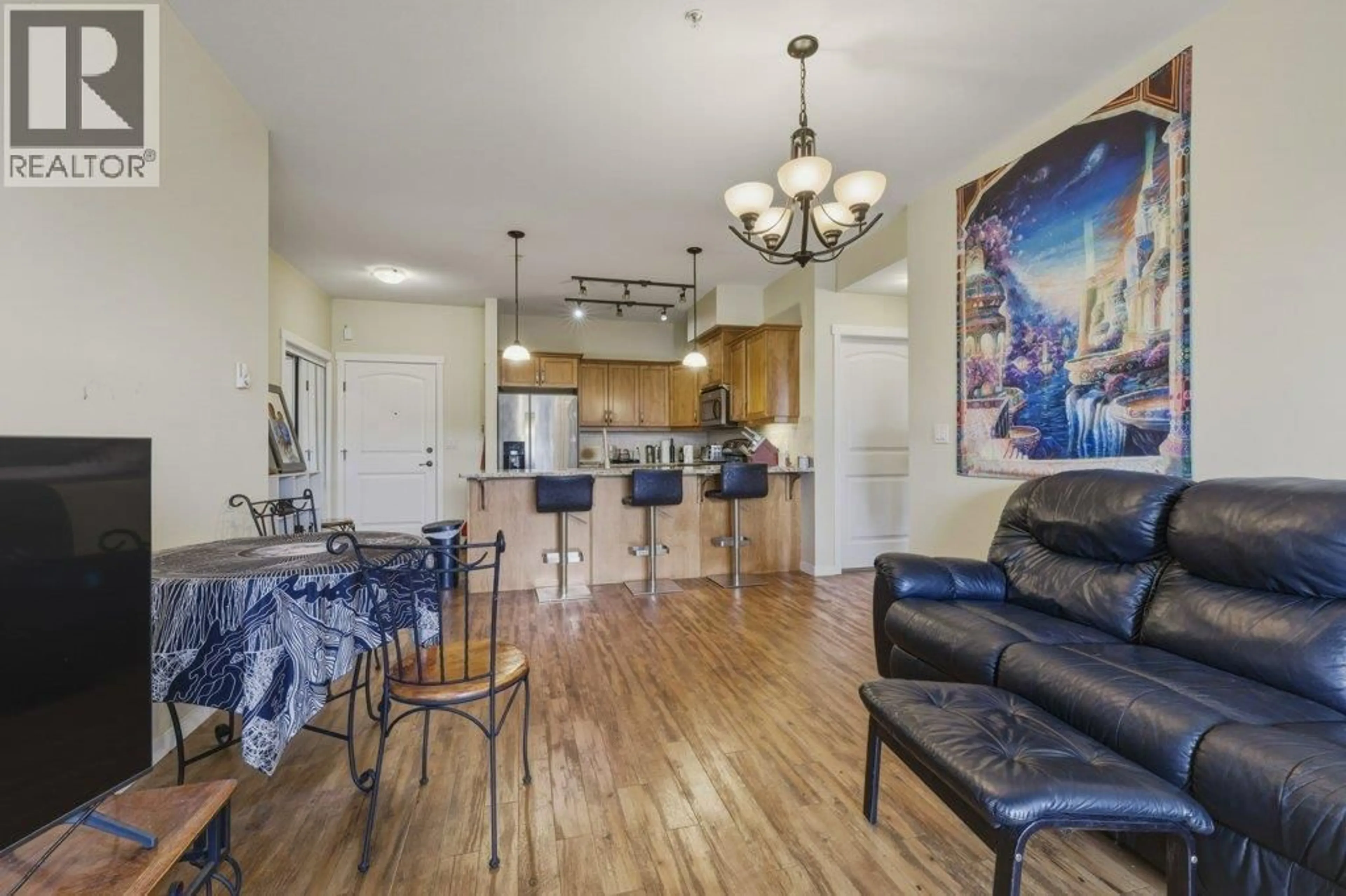 Open concept kitchen, wood/laminate floor for 316 - 3739 CASORSO ROAD, Kelowna British Columbia V1W5E8