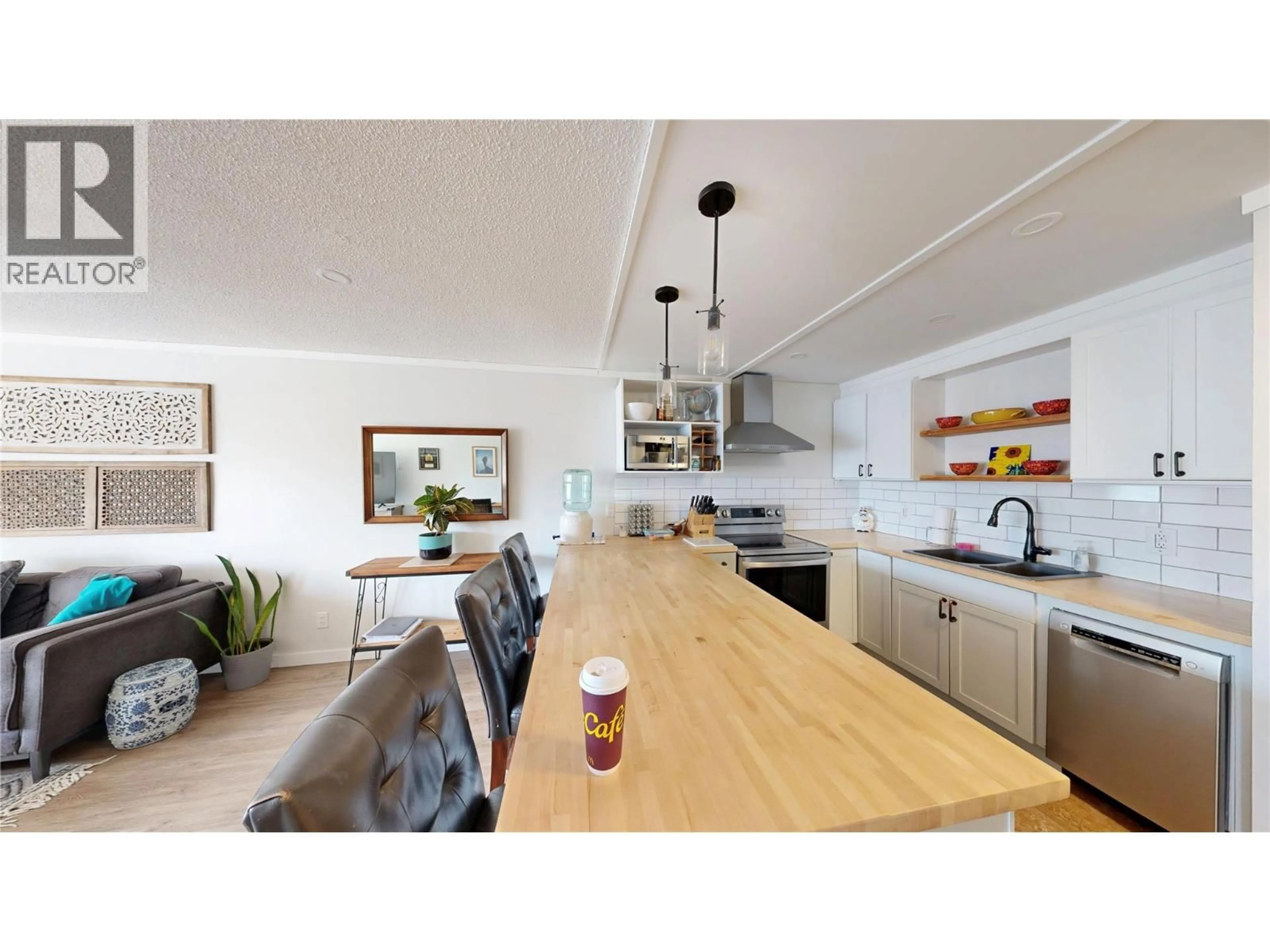 Open concept kitchen, wood/laminate floor for 406 - 737 LEON AVENUE, Kelowna British Columbia V1Y8L6