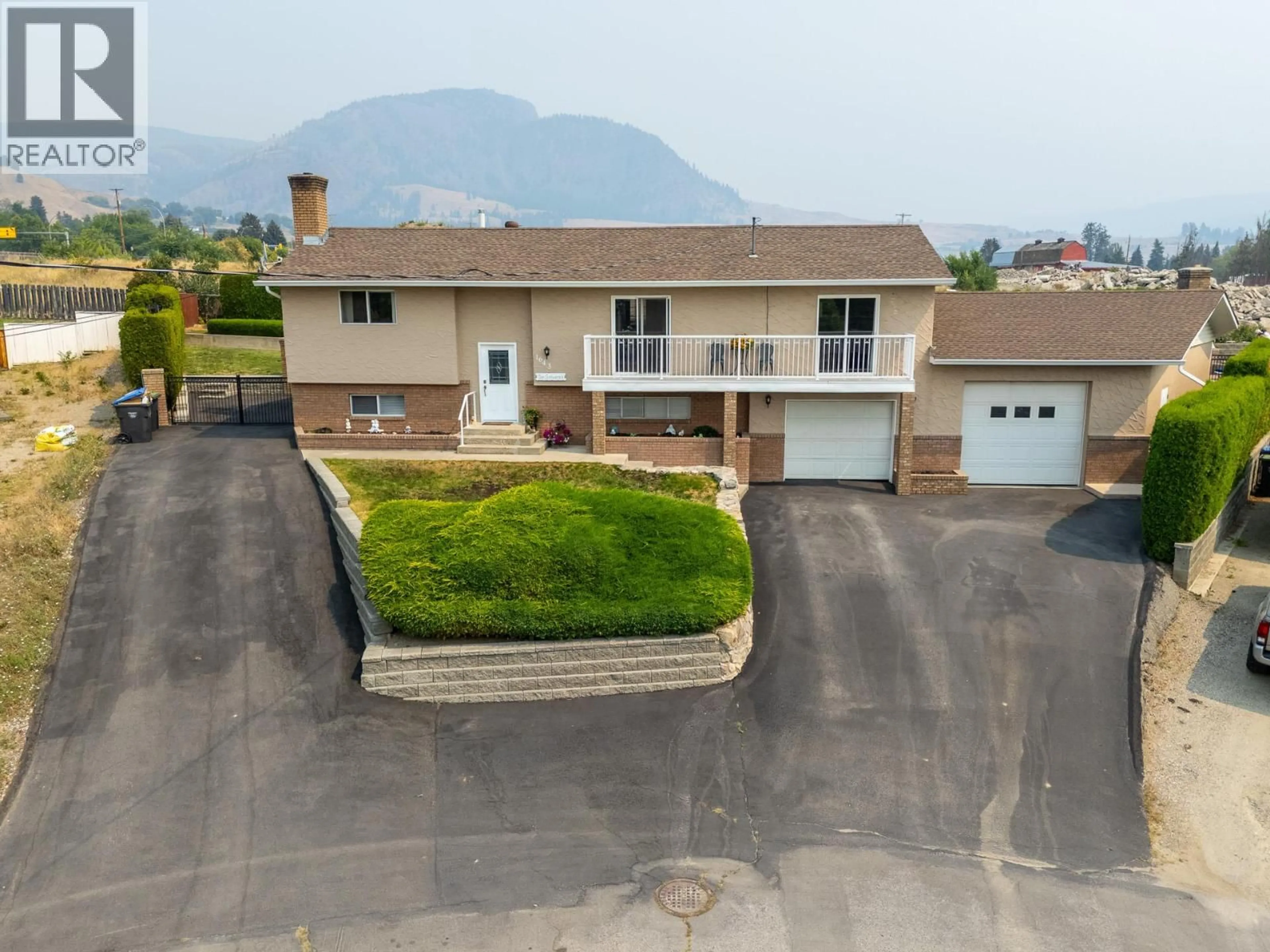 A pic from outside/outdoor area/front of a property/back of a property/a pic from drone, mountain view for 1643 TRAUT COURT, Kelowna British Columbia V1P1E6