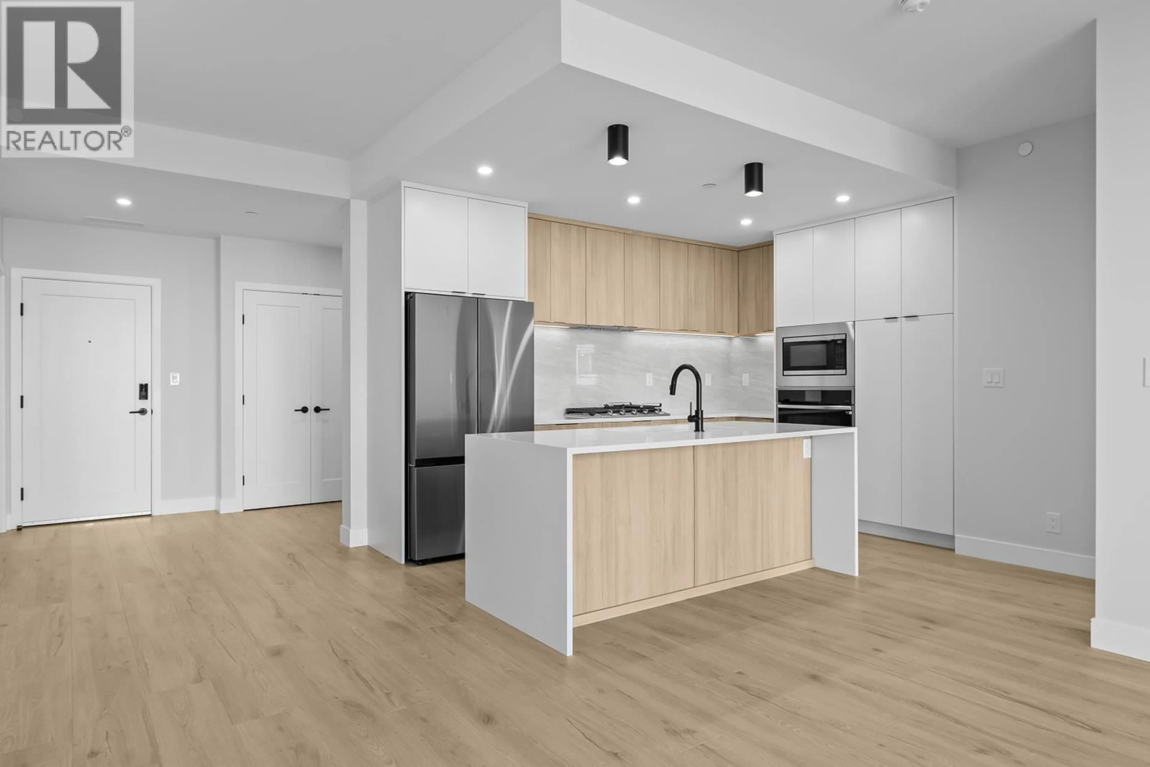 Open concept kitchen, unknown for 301 - 75 PREDATOR RIDGE DRIVE, Vernon British Columbia V1H1G4