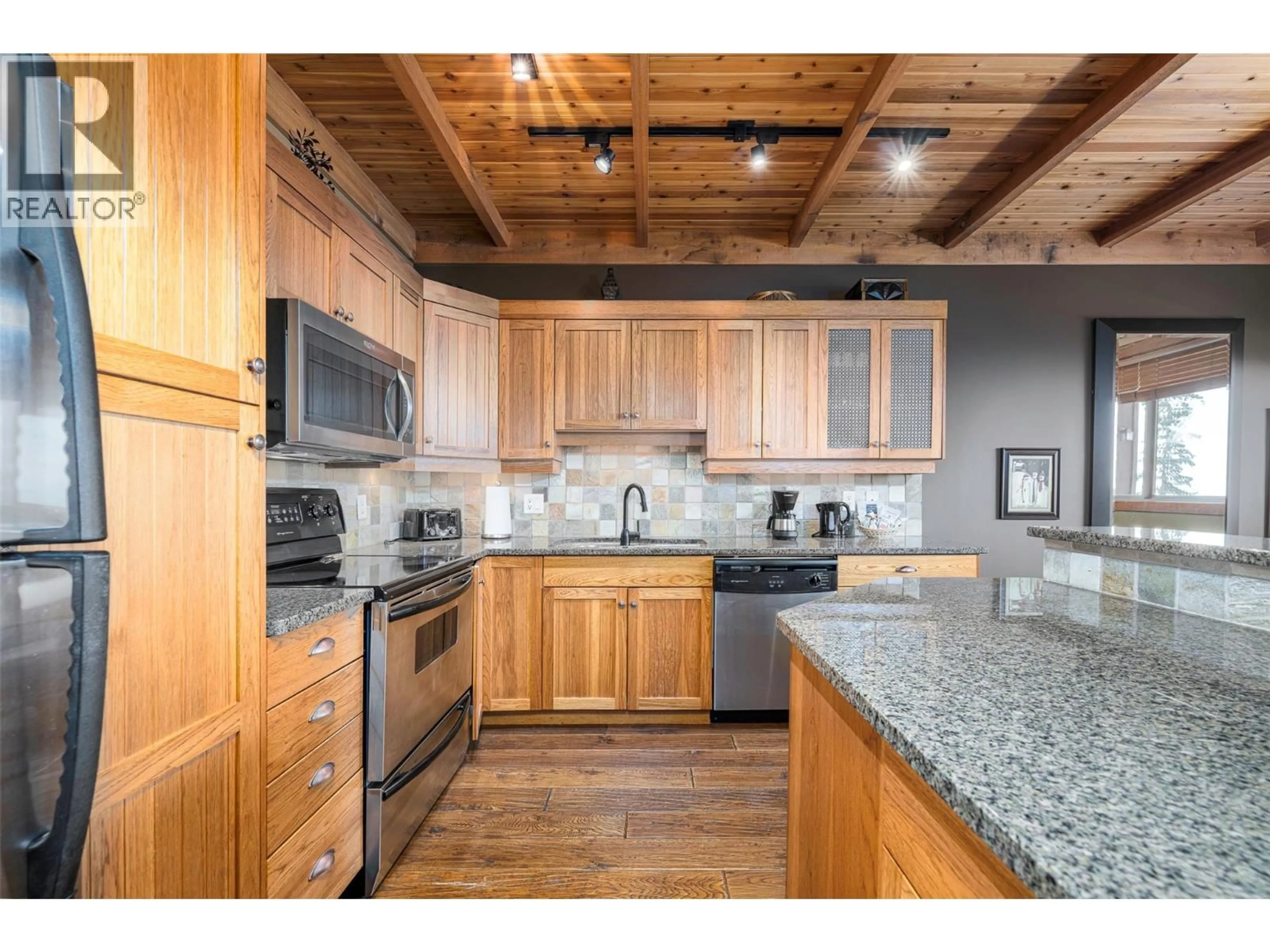 Open concept kitchen, wood/laminate floor for 205 - 250 FEATHERTOP WAY, Big White British Columbia V1P1T4