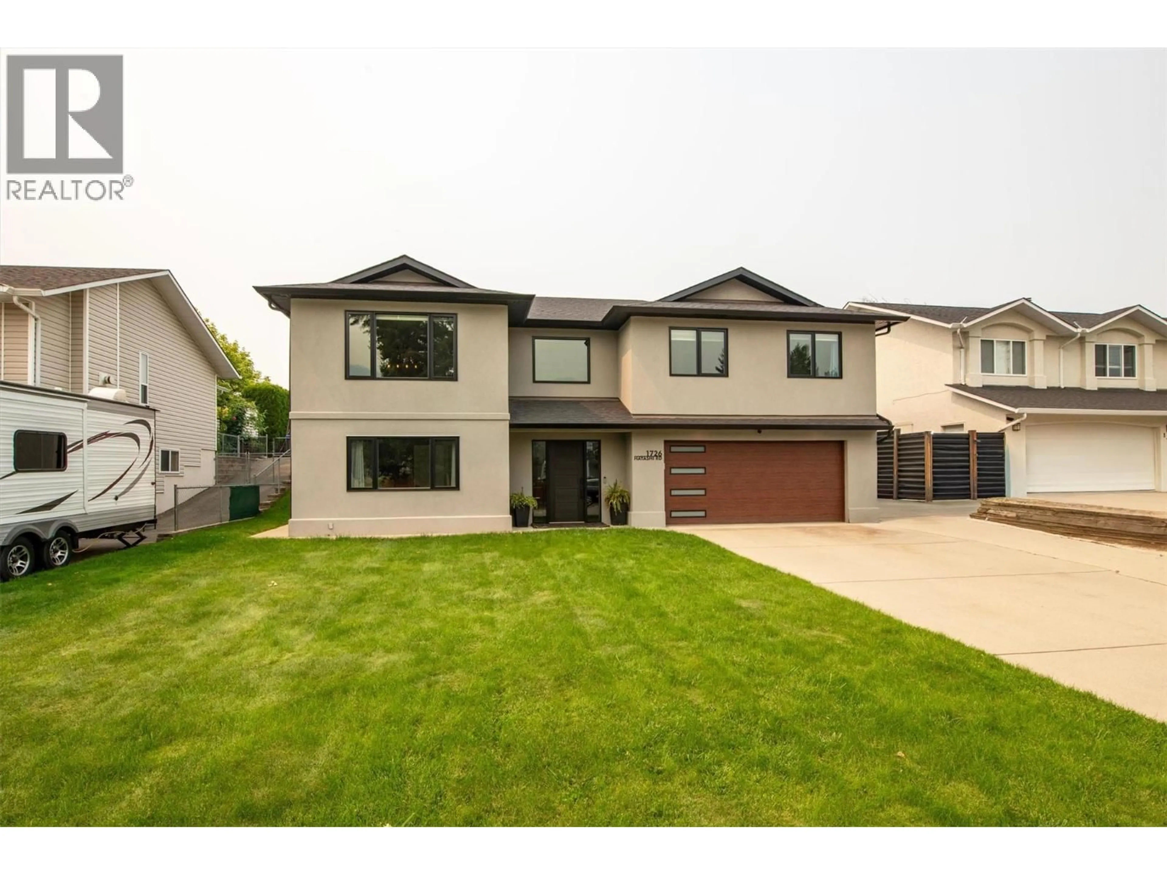 Home with vinyl exterior material, street for 1726 HAYASHI ROAD, Kelowna British Columbia V1P1B2