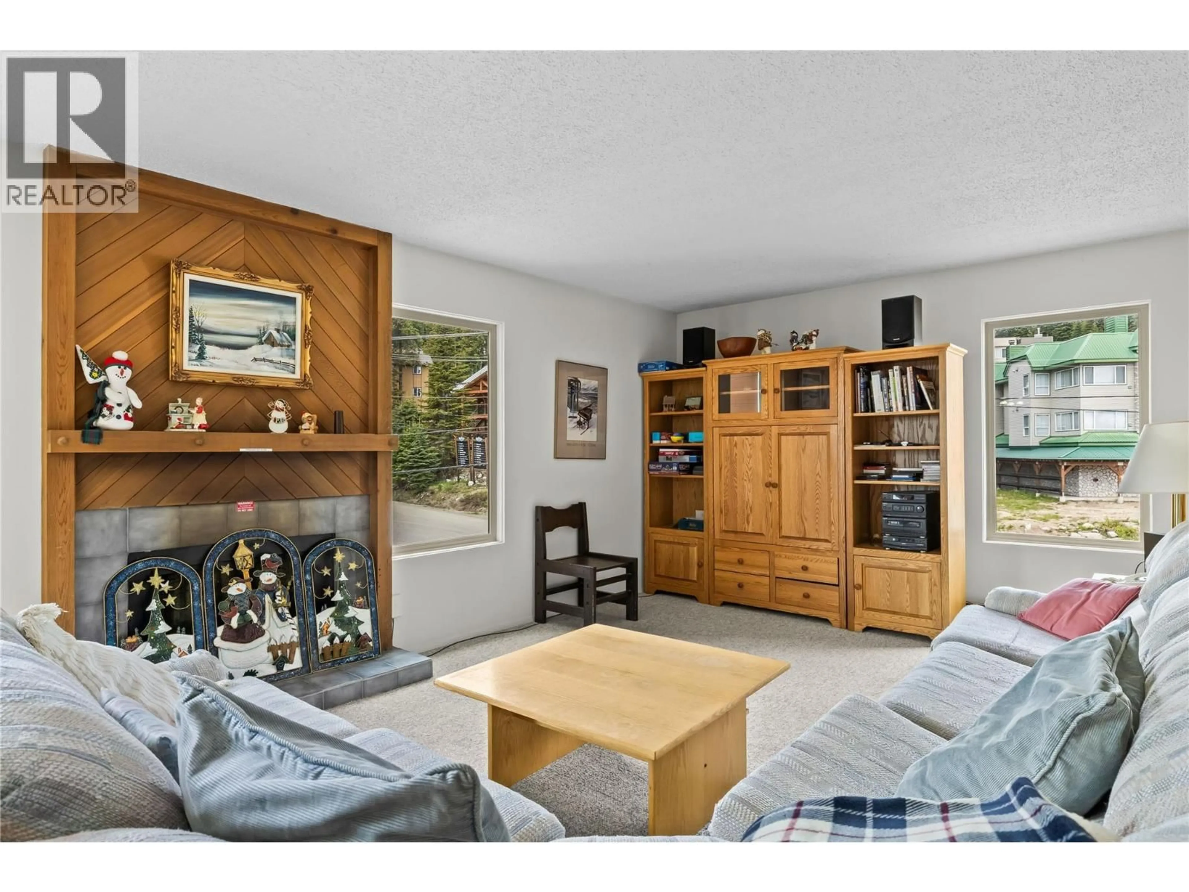 Living room with furniture, wood/laminate floor for 302 - 6430 WHISKEY JACK ROAD, Big White British Columbia V1P1T4