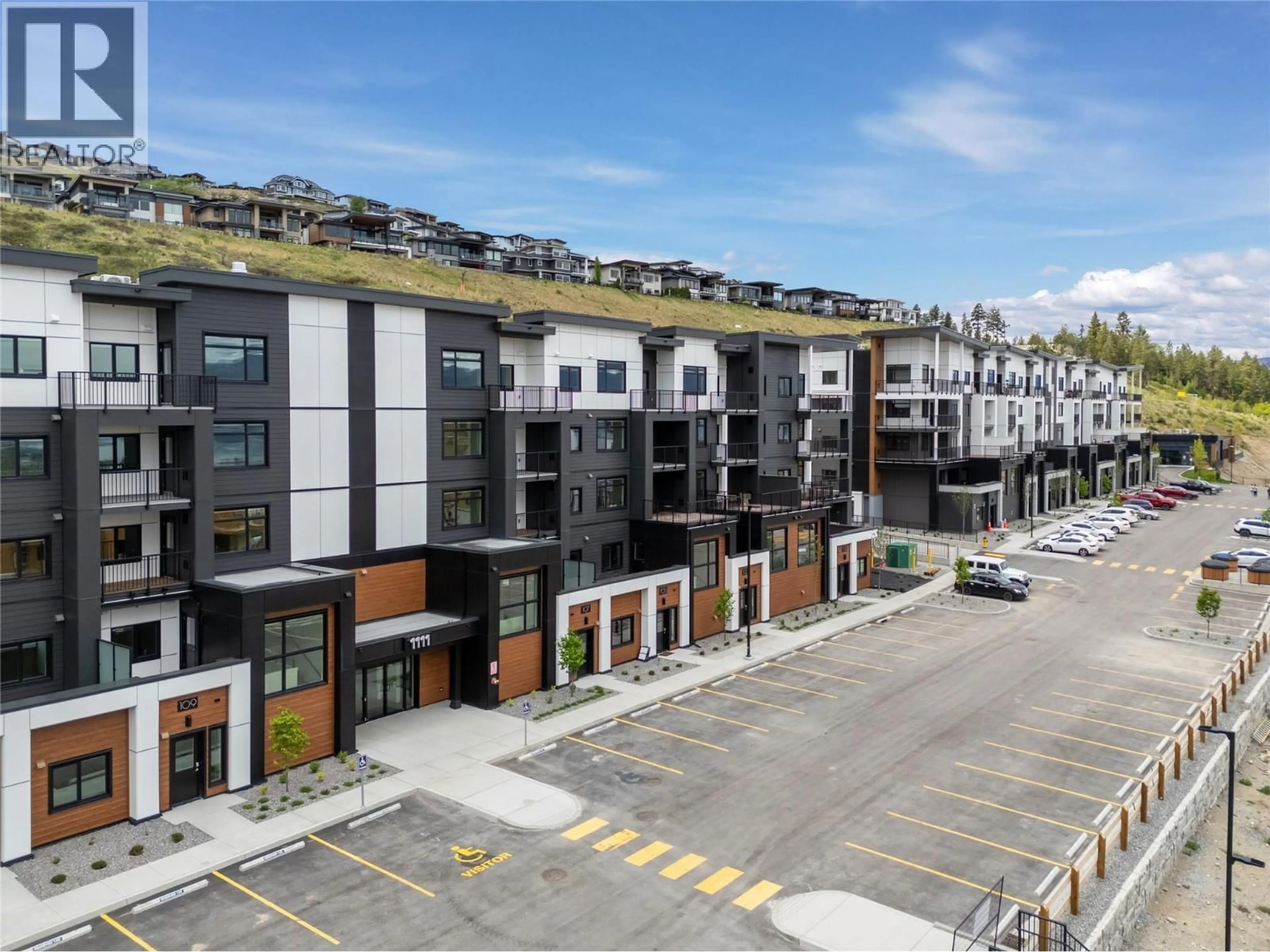 A pic from outside/outdoor area/front of a property/back of a property/a pic from drone, street for 404 - 1057 FROST ROAD, Kelowna British Columbia V1W0G7