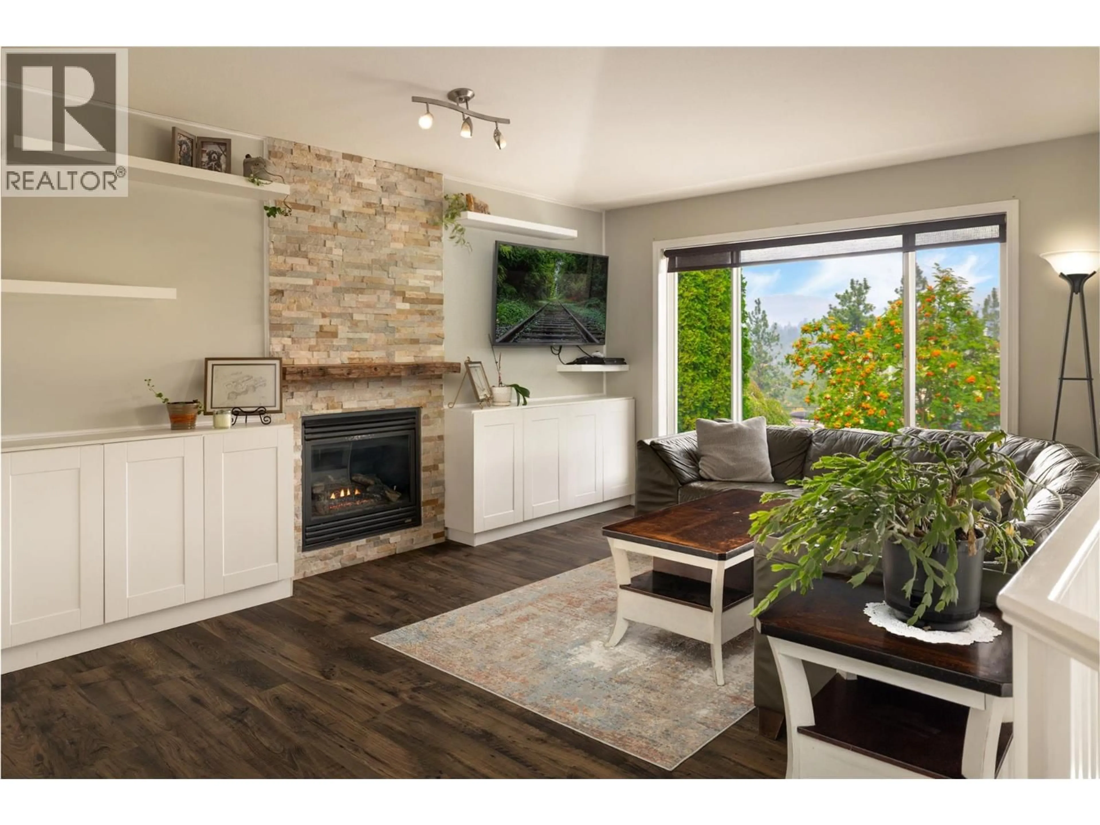 Living room with furniture, wood/laminate floor for 3013 BRINDISI PLACE, Kelowna British Columbia V1V2N5