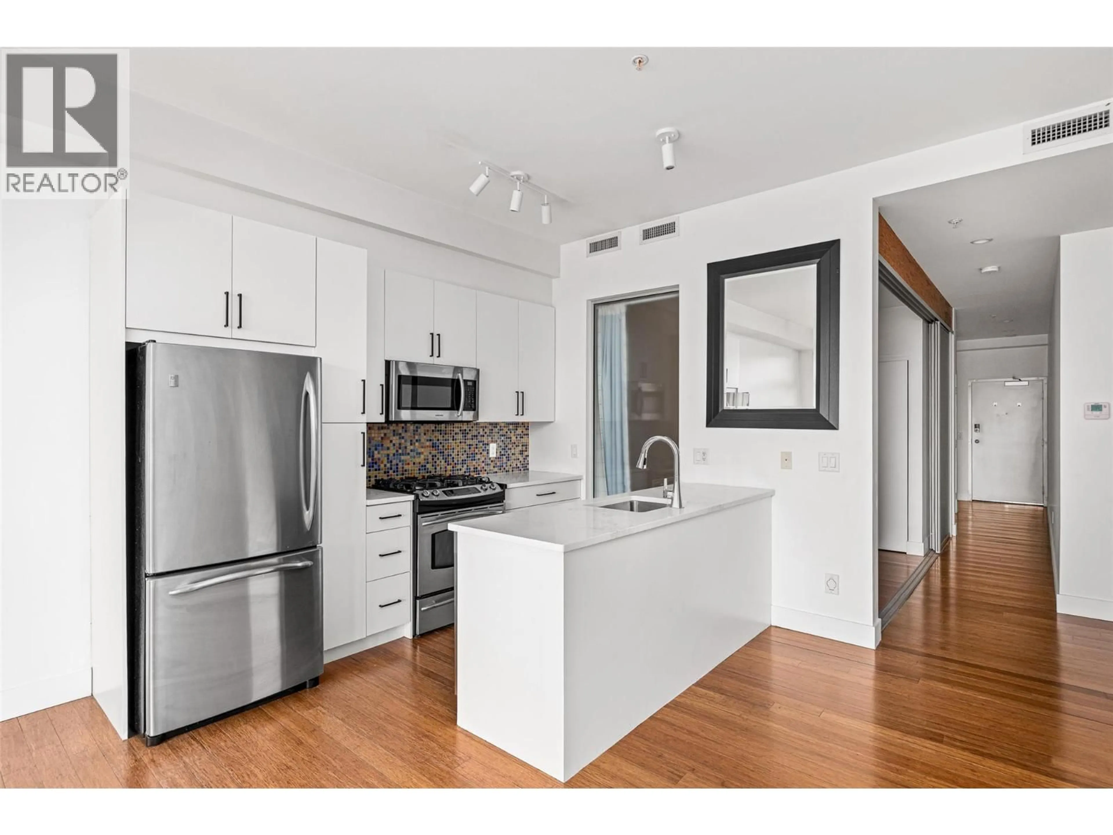 Open concept kitchen, wood/laminate floor for 316 - 1289 ELLIS STREET, Kelowna British Columbia V1Y9X6