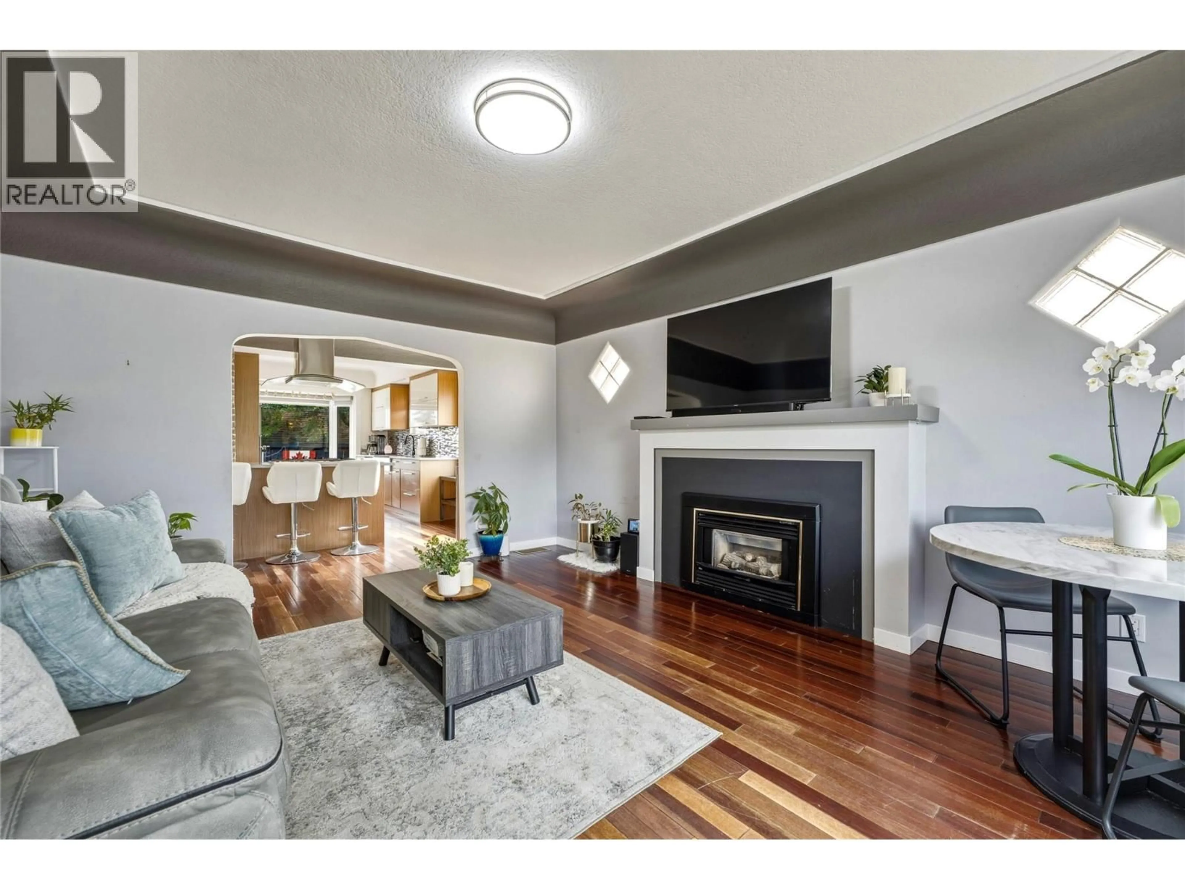 Living room with furniture, wood/laminate floor for 1701 34 STREET, Vernon British Columbia V1T5V7