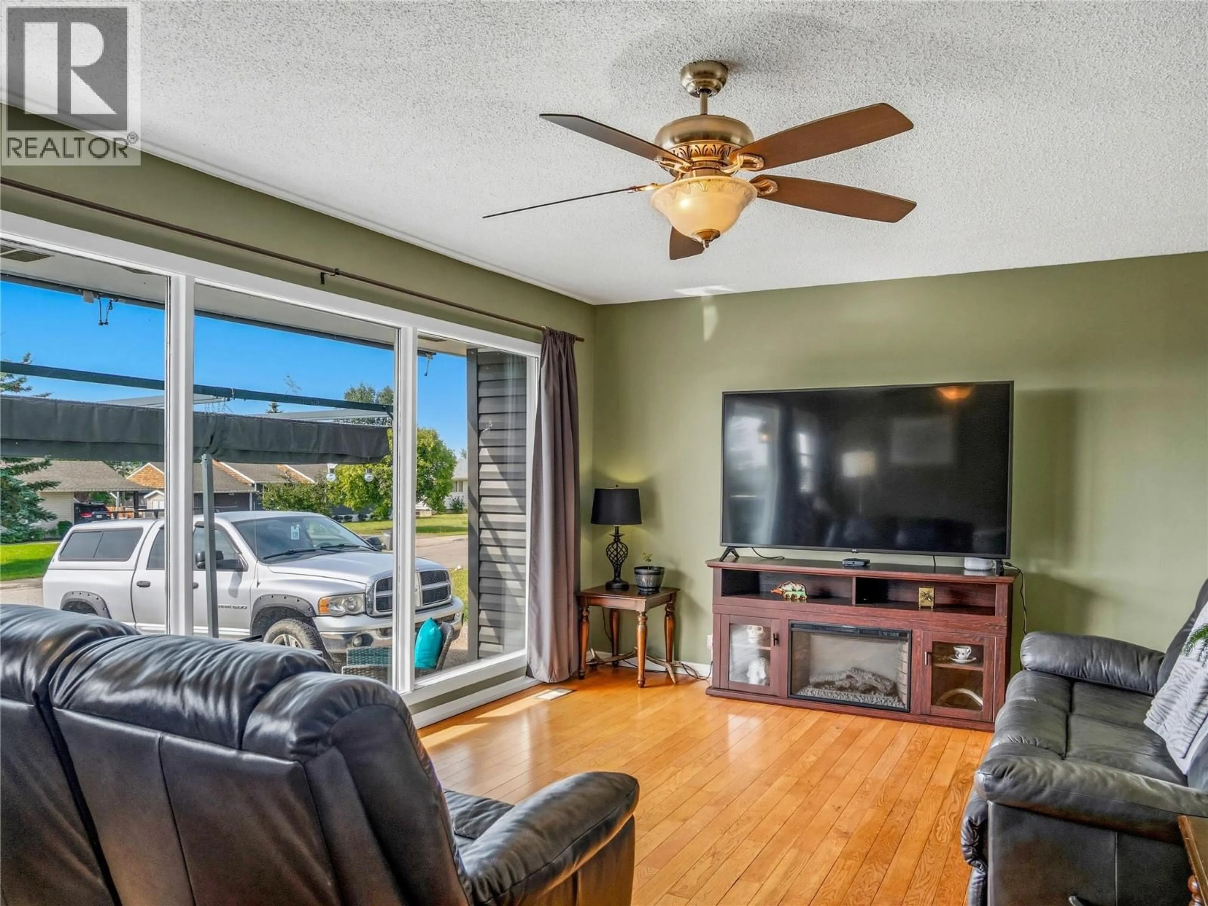 Living room with furniture, wood/laminate floor for 1324 93 AVENUE, Dawson Creek British Columbia V1G1E4