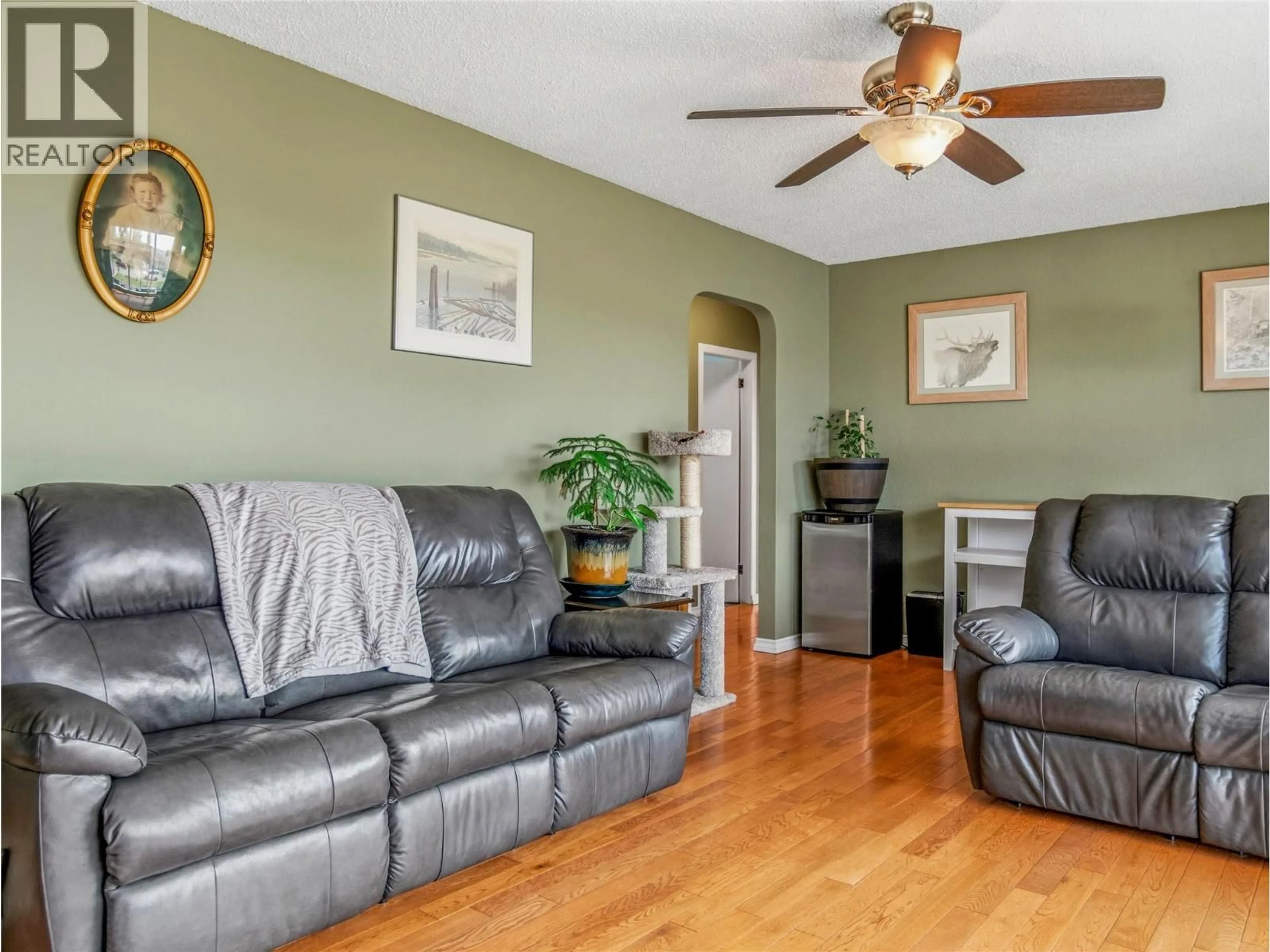 Living room with furniture, wood/laminate floor for 1324 93 AVENUE, Dawson Creek British Columbia V1G1E4