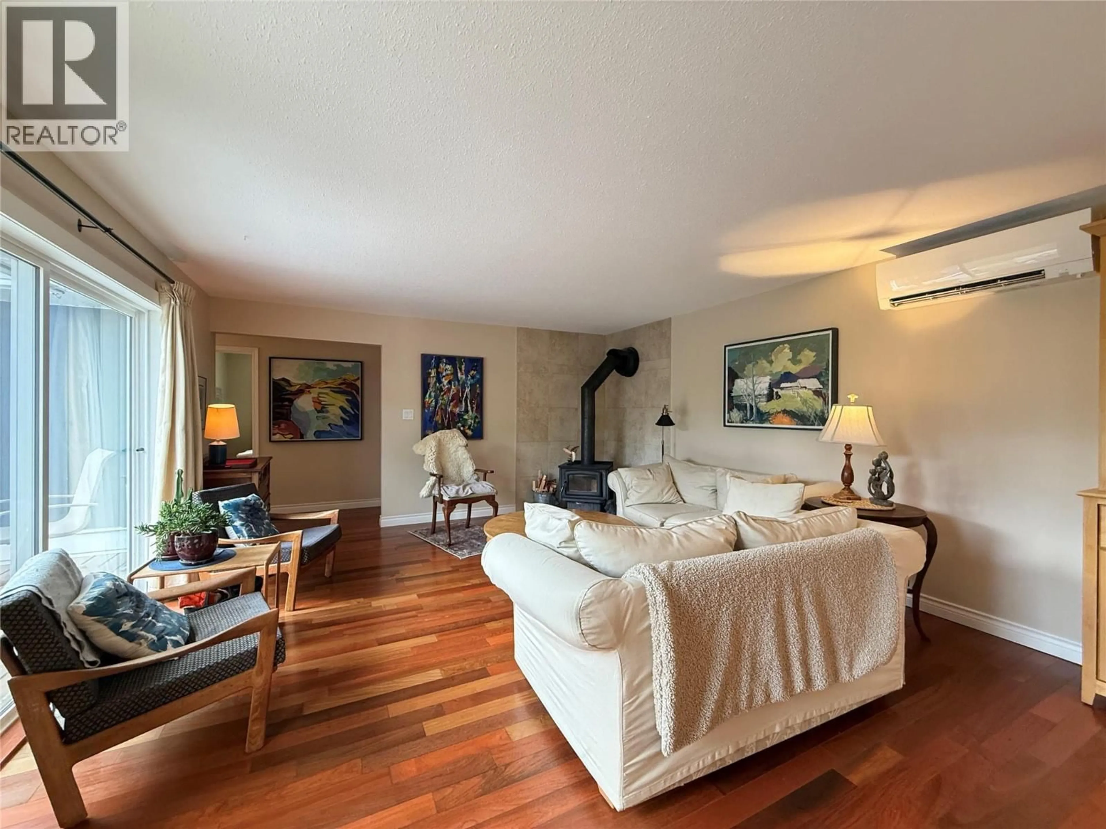 Living room with furniture, wood/laminate floor for 3834 WOODCREST ROAD, Bonnington British Columbia V0G2G3