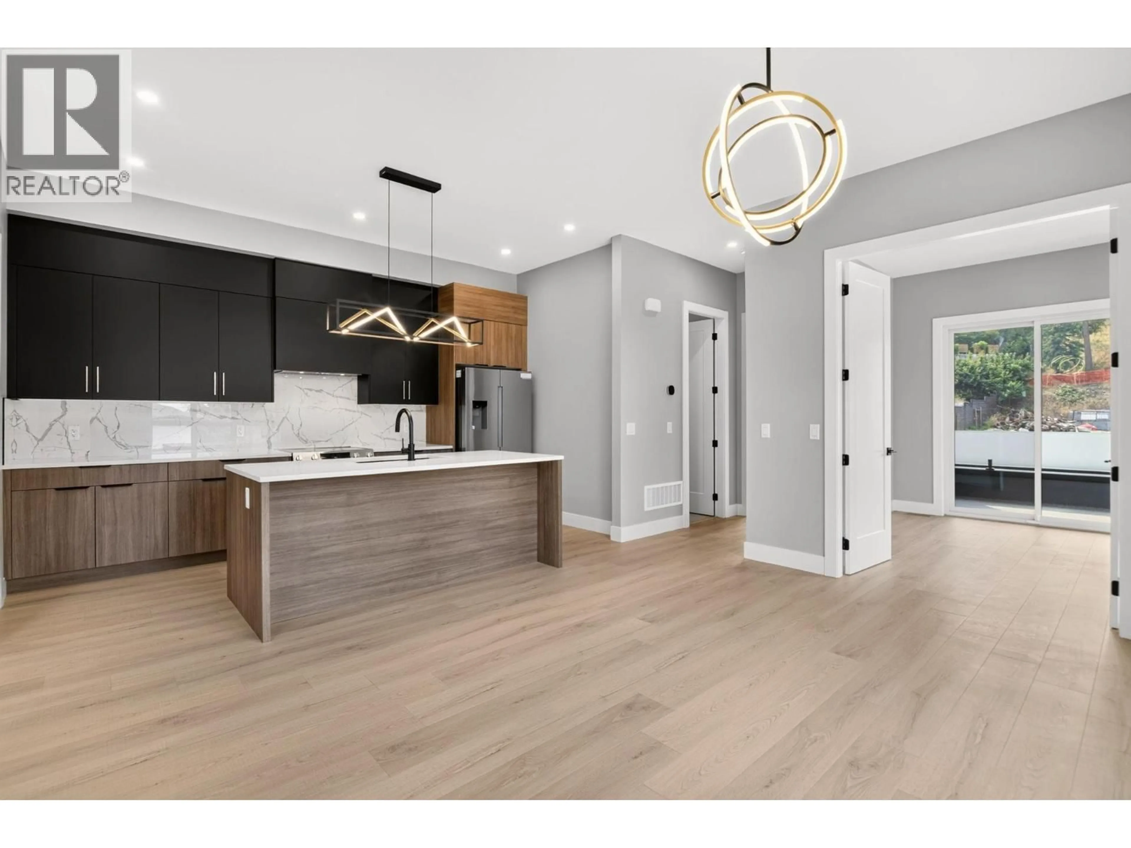 Open concept kitchen, wood/laminate floor for 1 - 757 BARNABY ROAD, Kelowna British Columbia V1W4N9