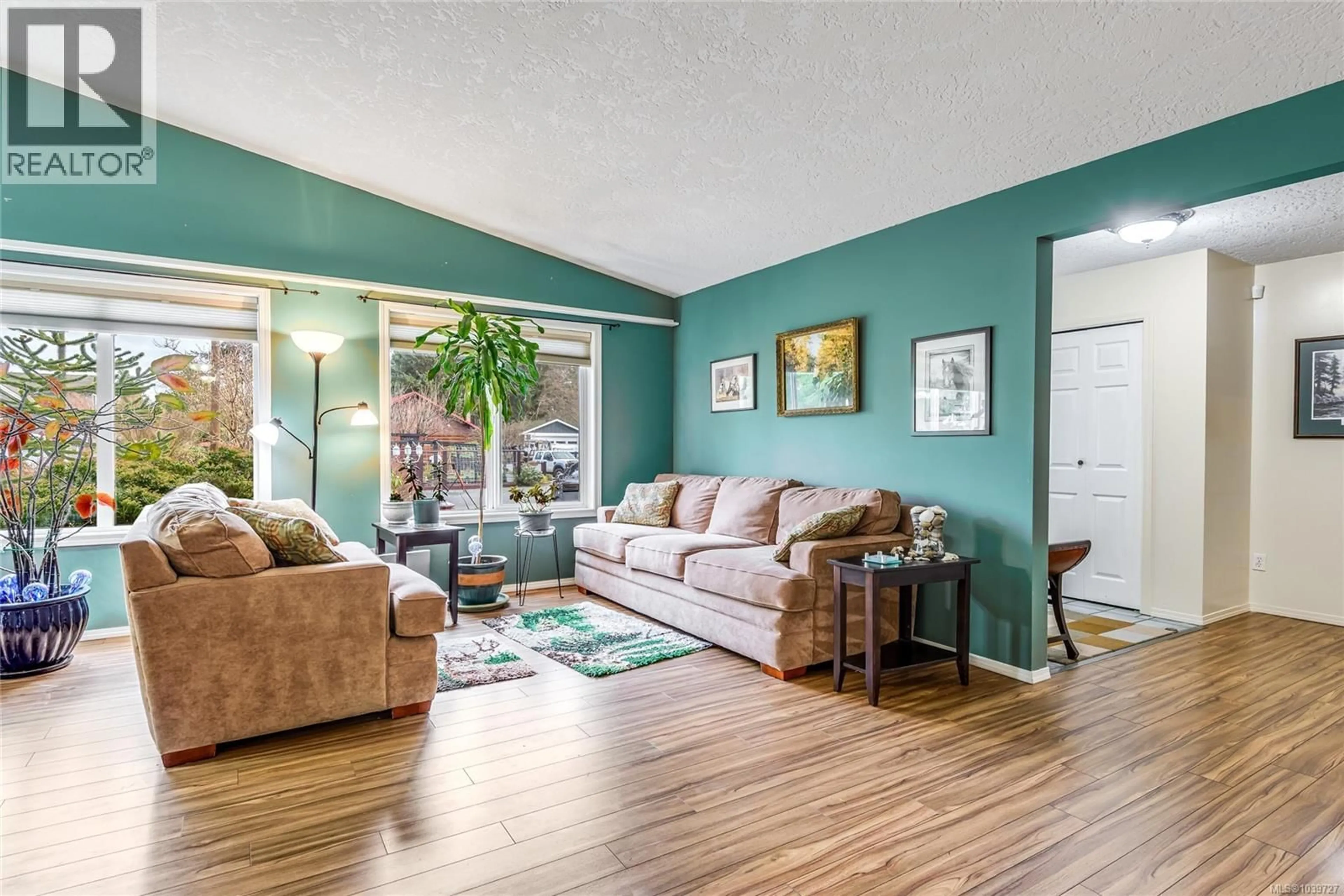 Living room with furniture, wood/laminate floor for 8955 MCLAREY AVENUE, Black Creek British Columbia V9J1A2
