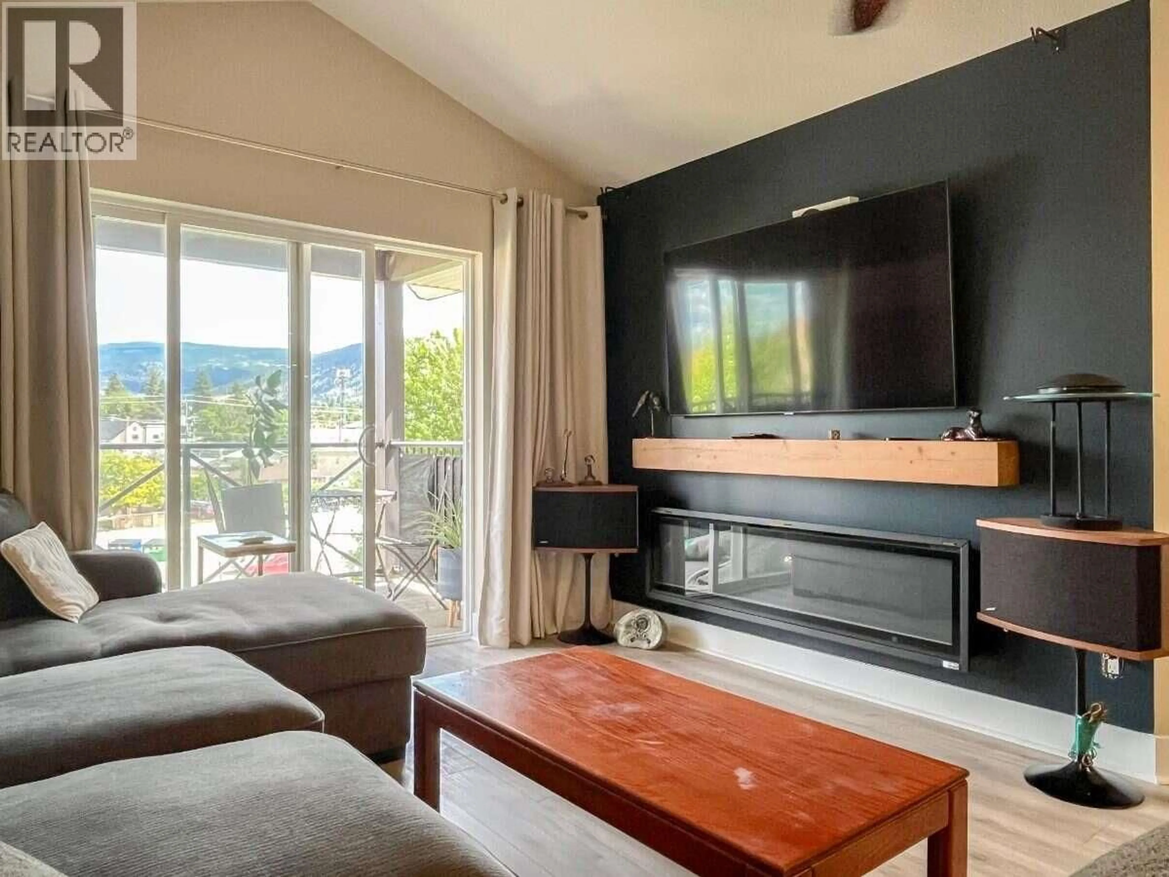 Living room with furniture, wood/laminate floor for 405 - 246 HASTINGS AVENUE, Penticton British Columbia V2A2V6