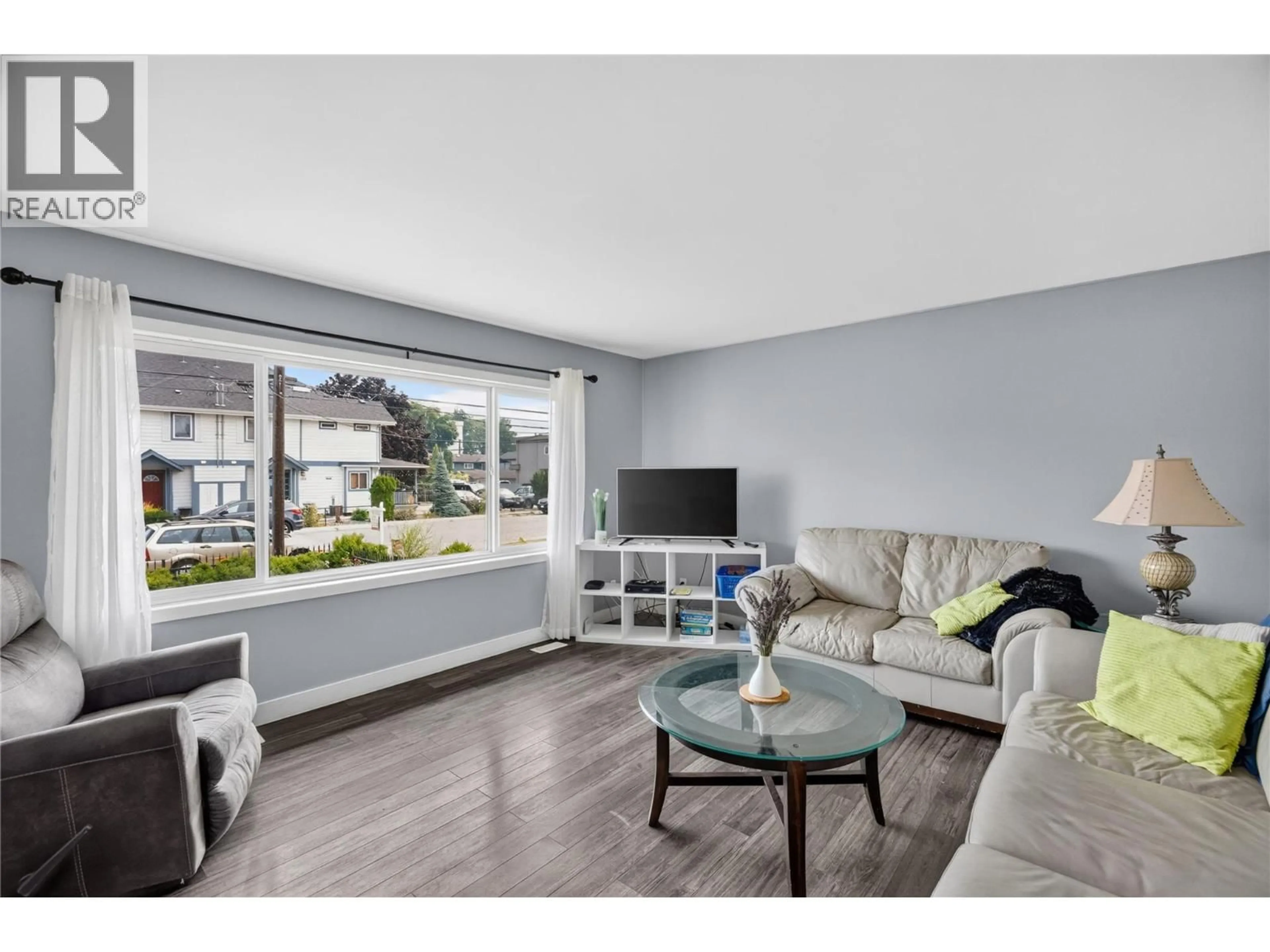 Living room with furniture, wood/laminate floor for 317 HAYNES STREET, Penticton British Columbia V2A5S1