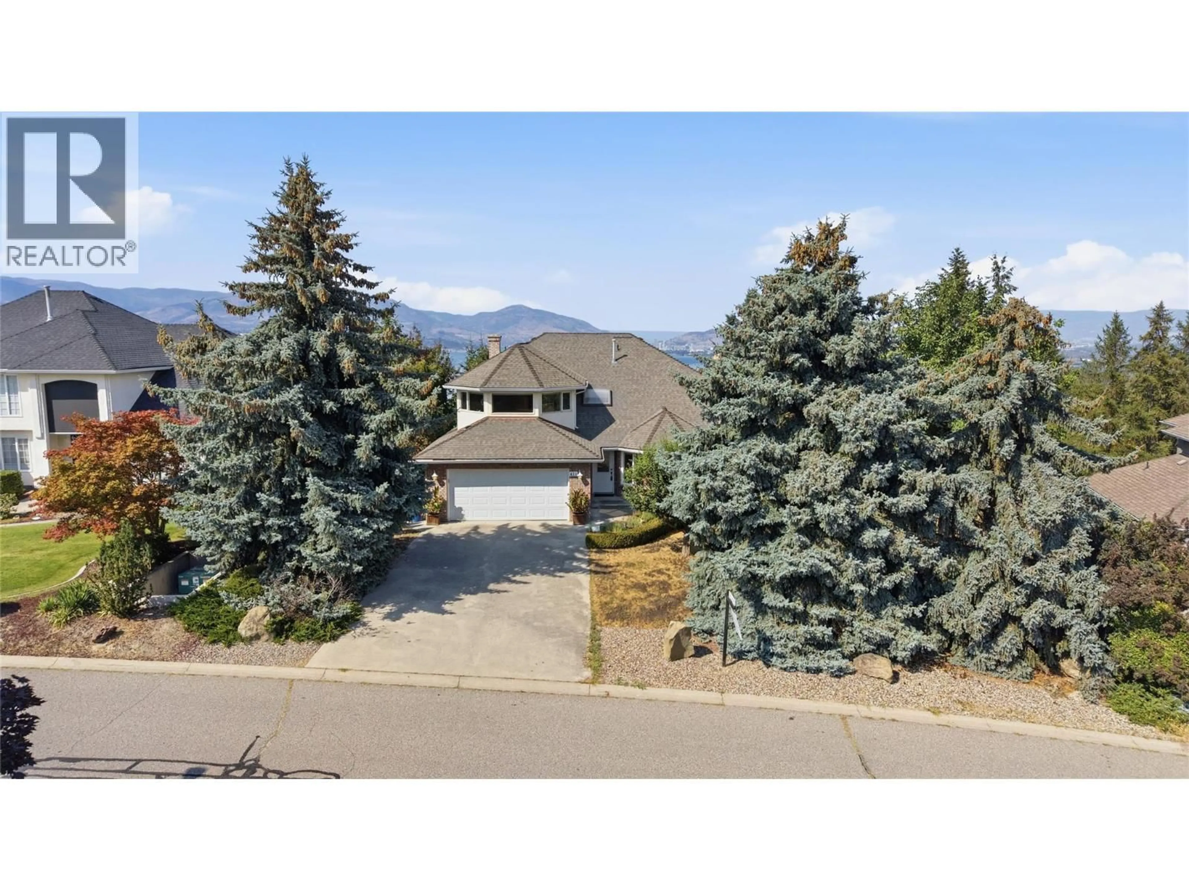 A pic from outside/outdoor area/front of a property/back of a property/a pic from drone, mountain view for 411 CURLEW DRIVE, Kelowna British Columbia V1W4L3