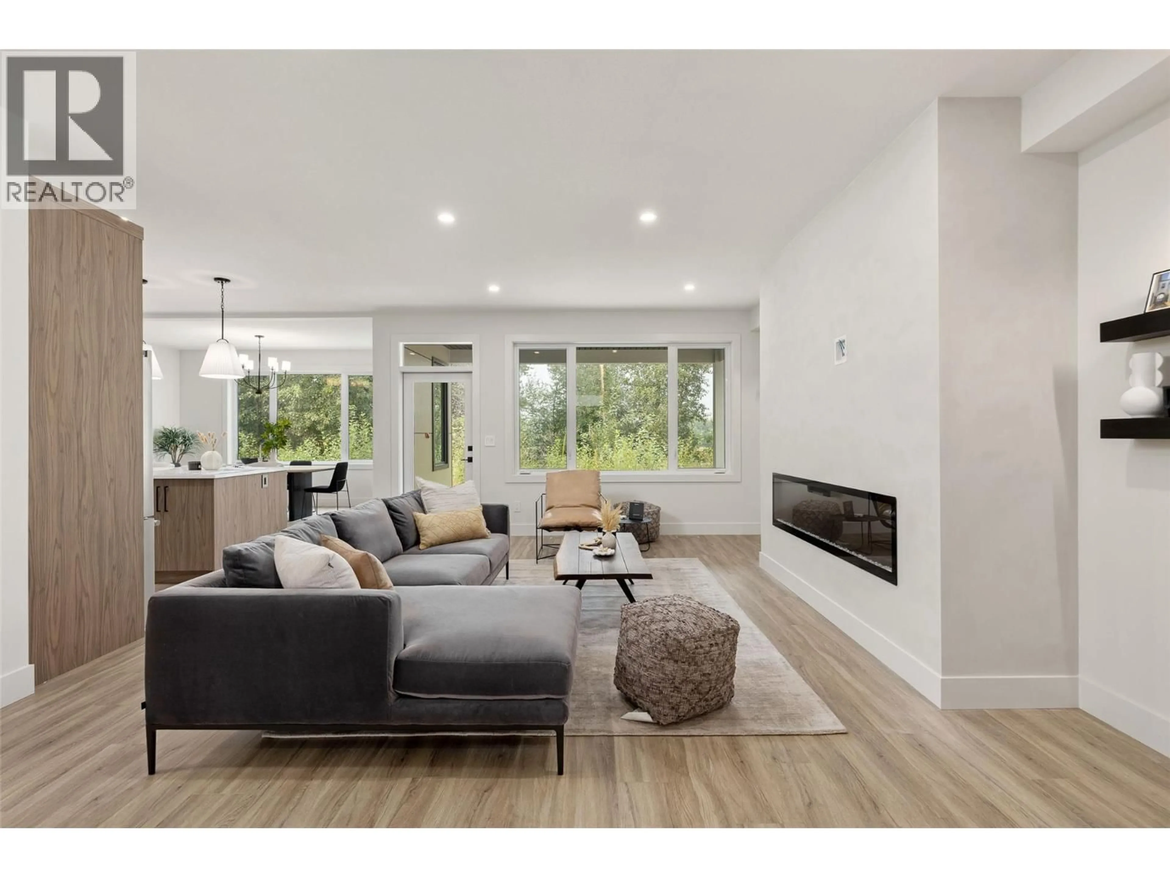 Living room with furniture, wood/laminate floor for 912 BULL CRESCENT, Kelowna British Columbia V1W4N2