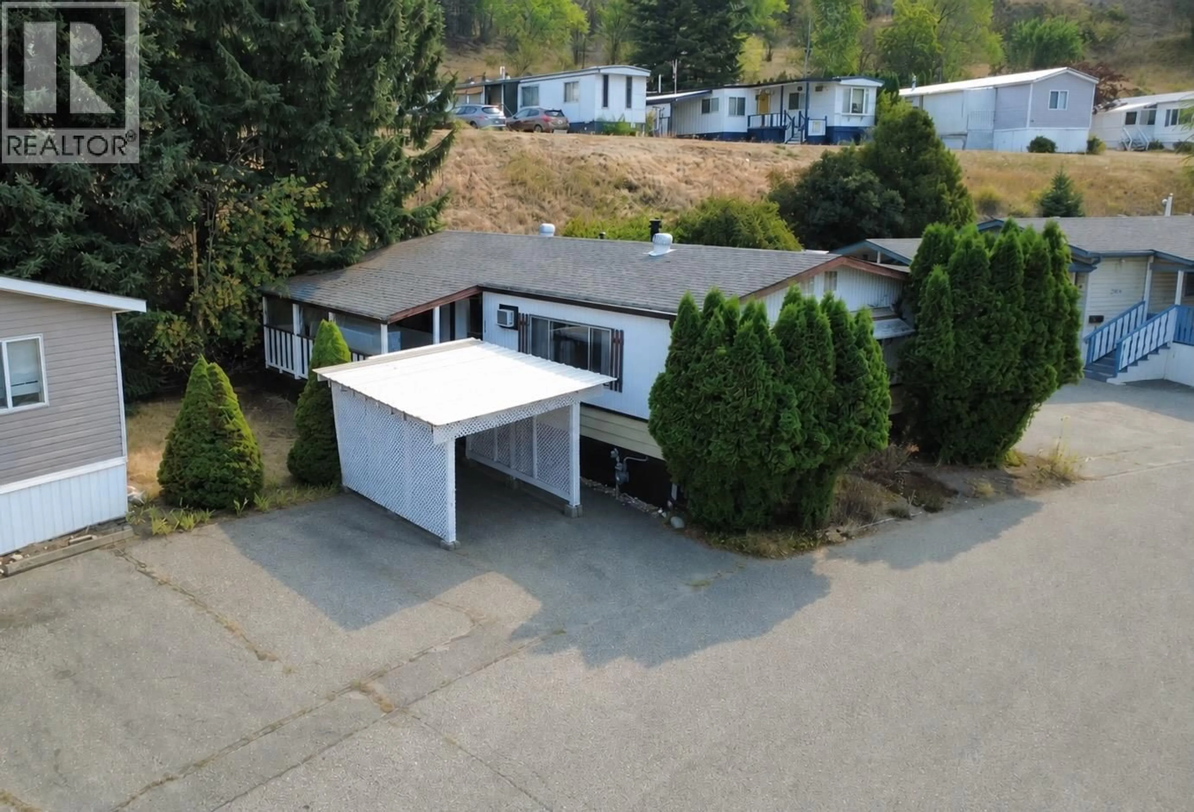 A pic from outside/outdoor area/front of a property/back of a property/a pic from drone, street for 308 15401 KALAMALKA ROAD, Vernon British Columbia V1H2A7