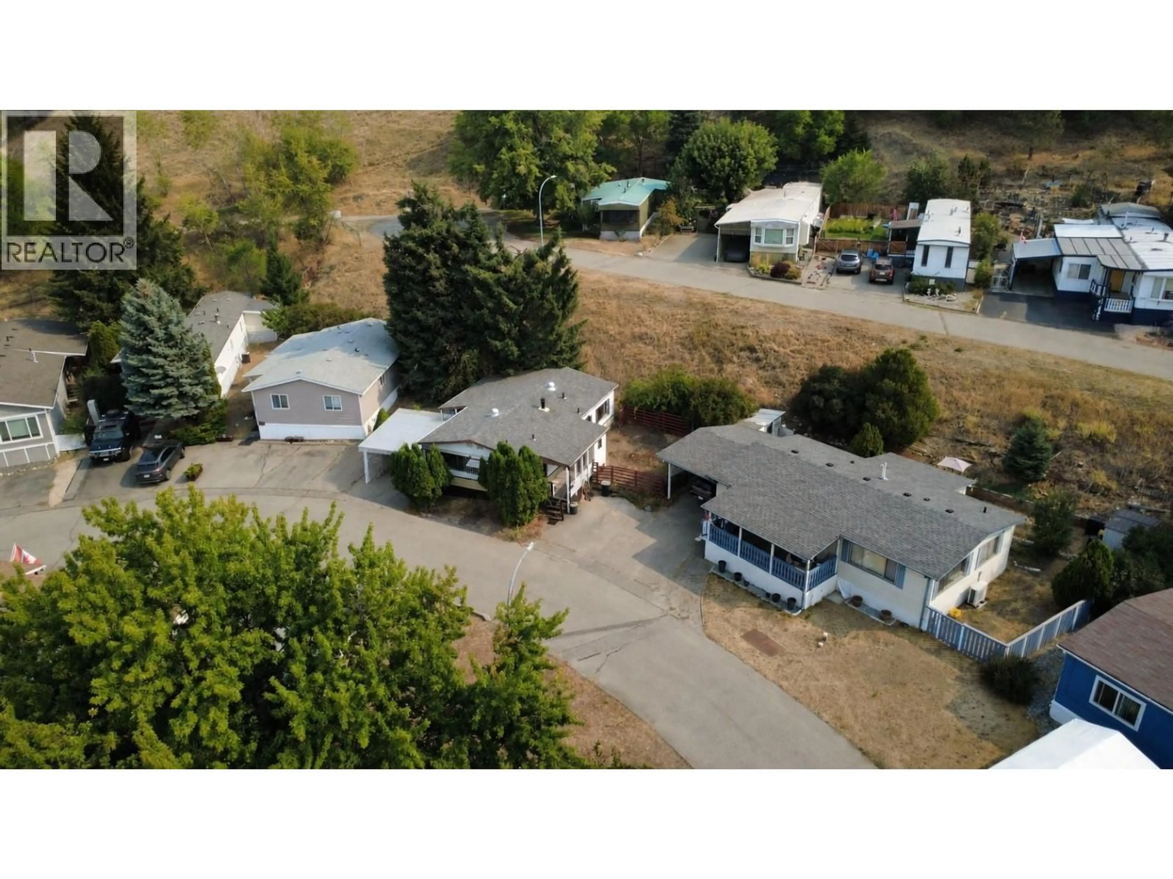 A pic from outside/outdoor area/front of a property/back of a property/a pic from drone, street for 308 15401 KALAMALKA ROAD, Vernon British Columbia V1H2A7