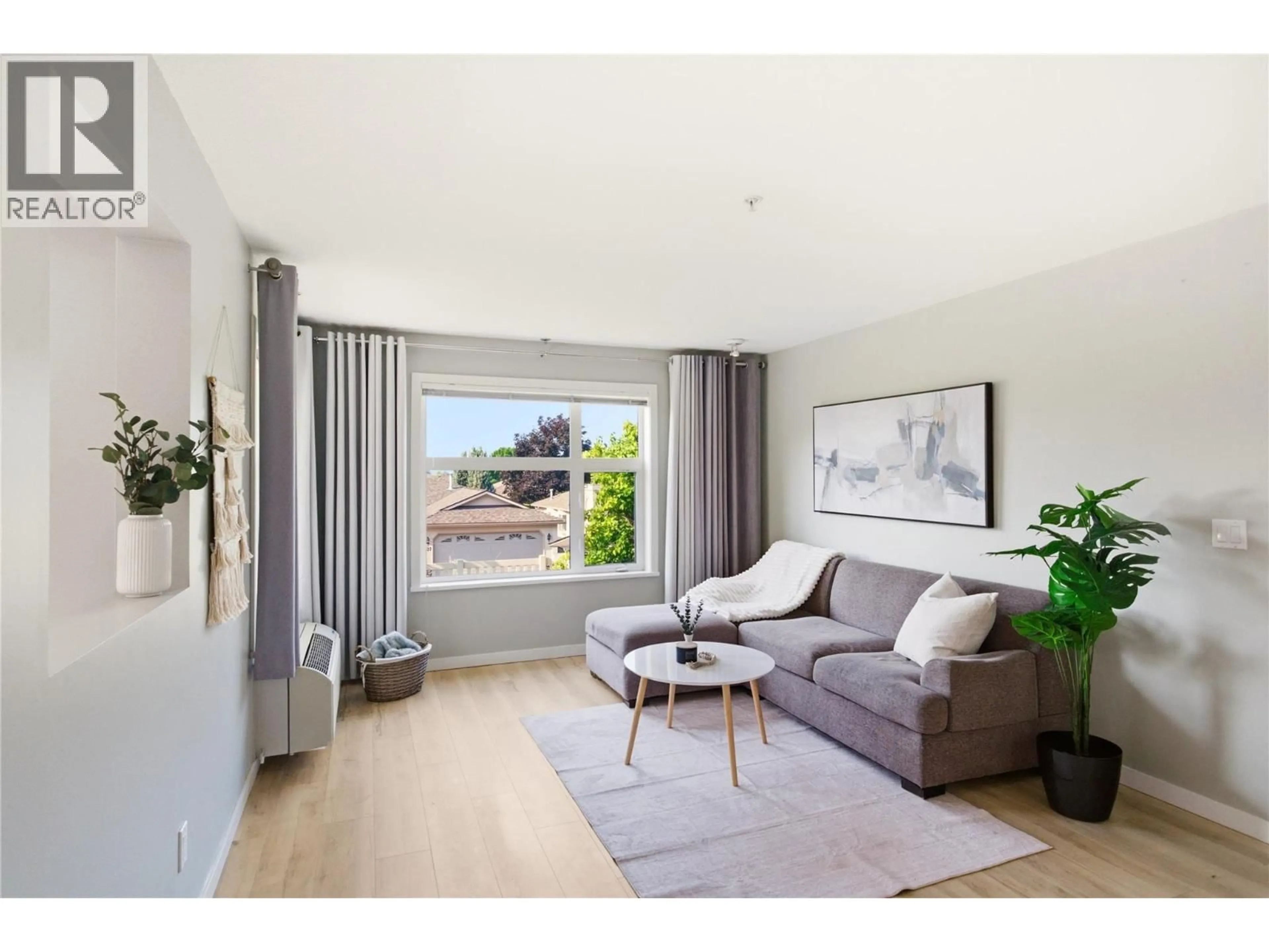 Living room with furniture, wood/laminate floor for 215 - 563 YATES ROAD, Kelowna British Columbia V1V2V3
