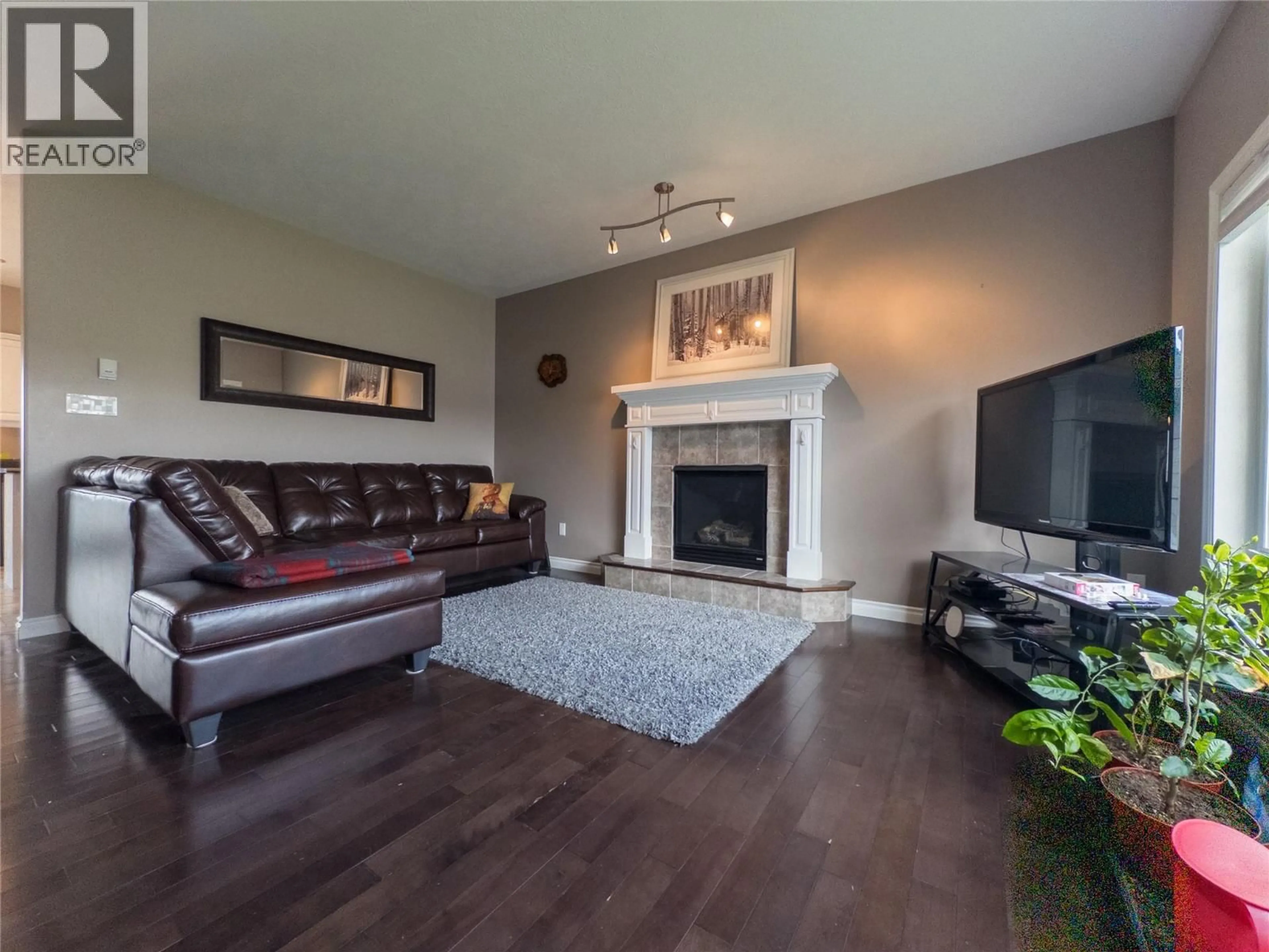 Living room with furniture, wood/laminate floor for 8705 18 STREET, Dawson Creek British Columbia V1G0B3