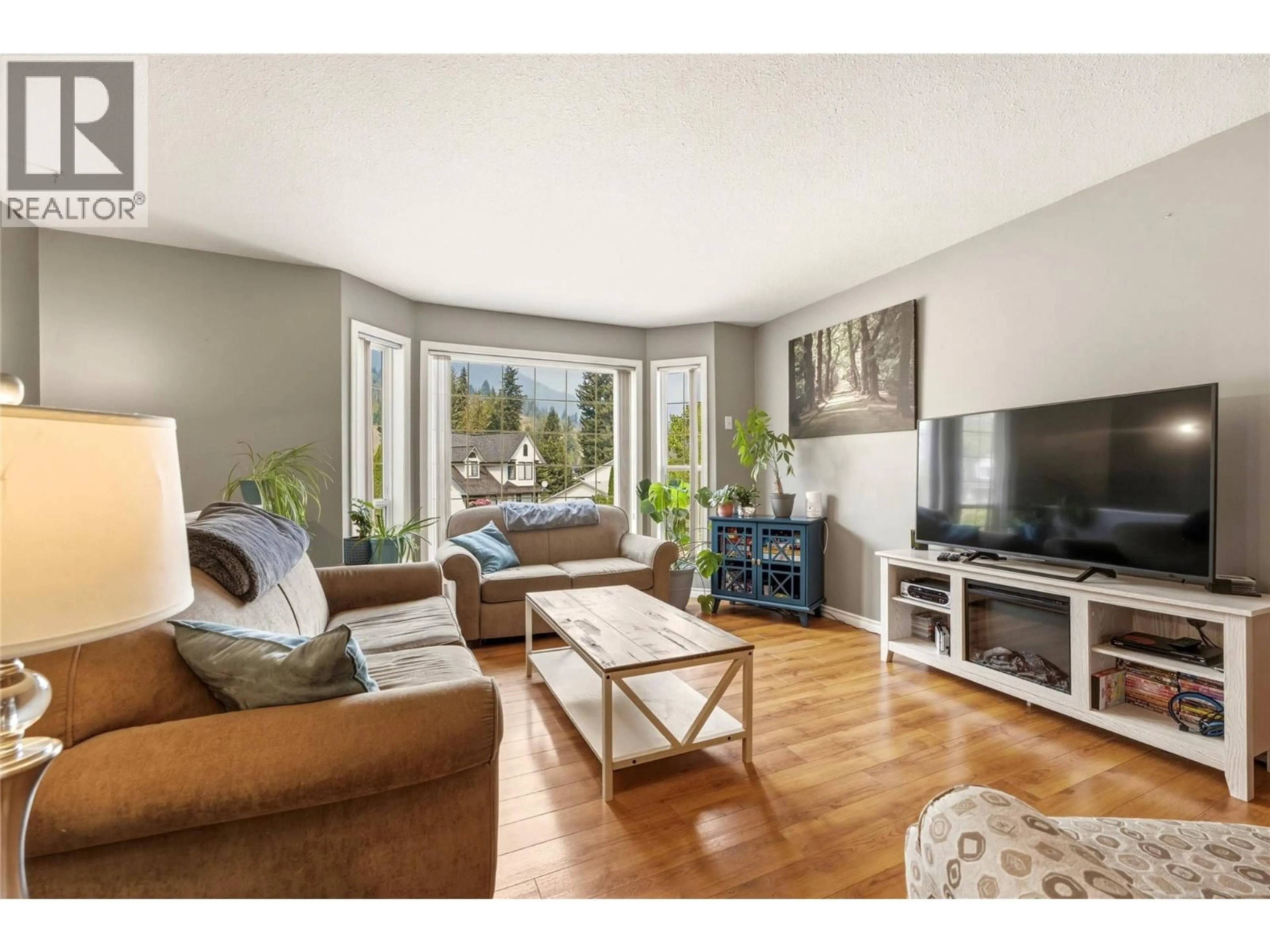 Living room with furniture, wood/laminate floor for 2228 LINEA CRESCENT, Lumby British Columbia V0E2G0