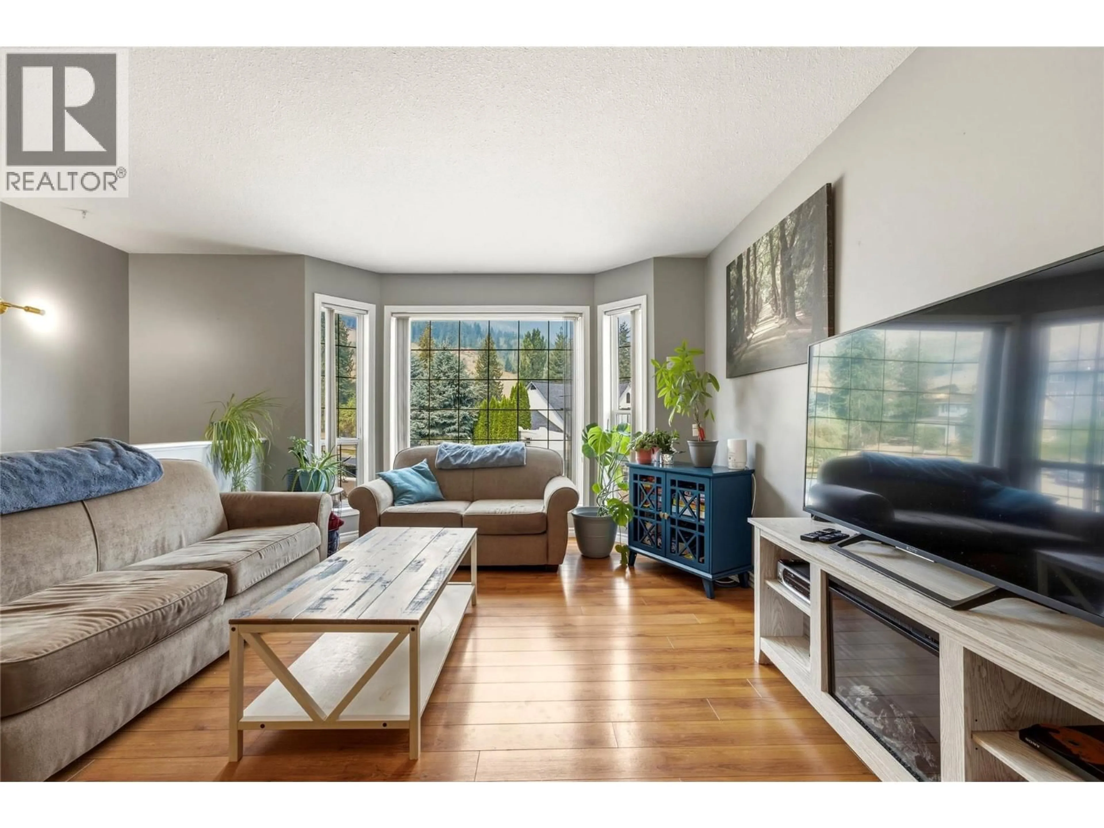 Living room with furniture, wood/laminate floor for 2228 LINEA CRESCENT, Lumby British Columbia V0E2G0