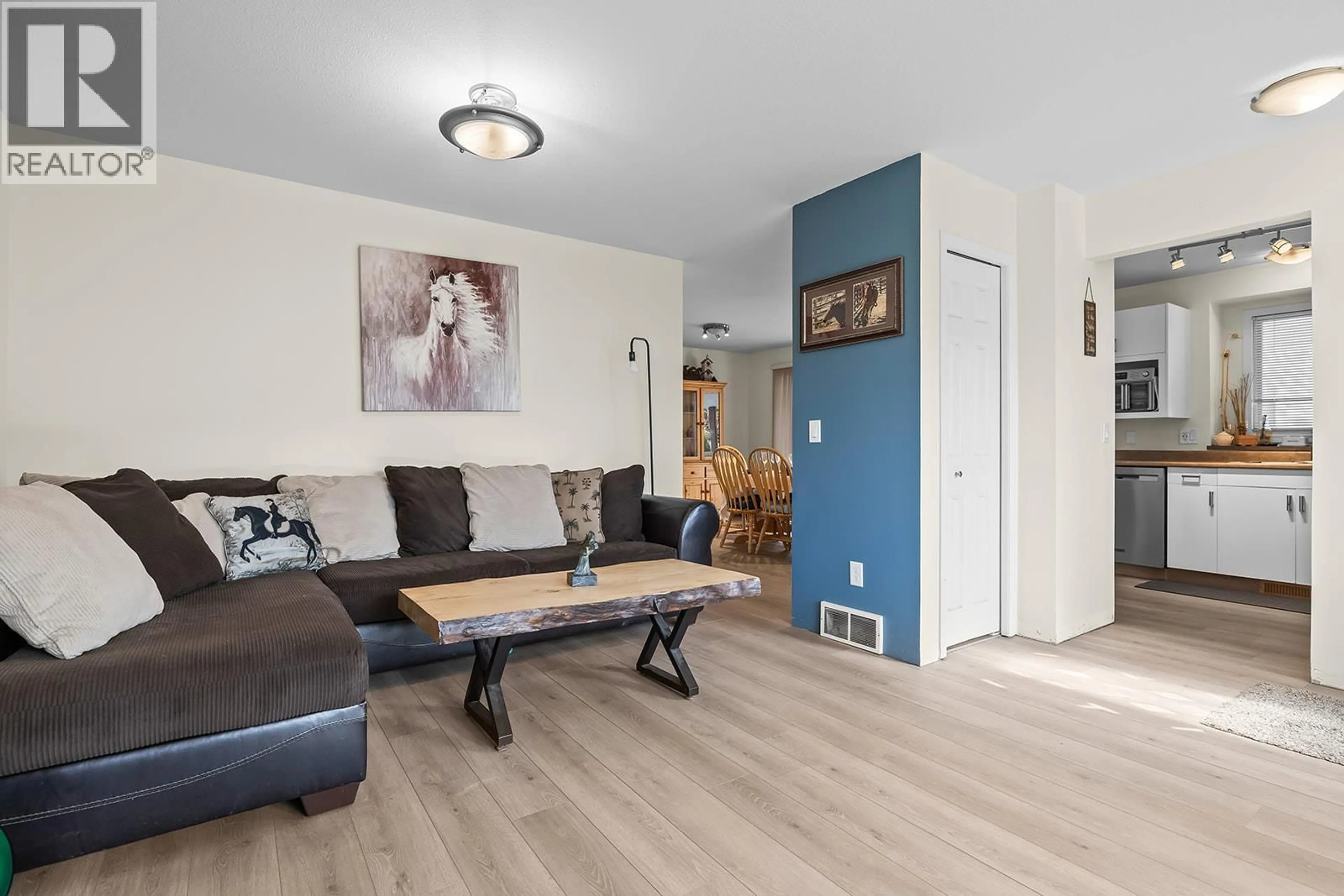 Living room with furniture, wood/laminate floor for 22 - 6400 SPENCER ROAD, Kelowna British Columbia V1X7T6