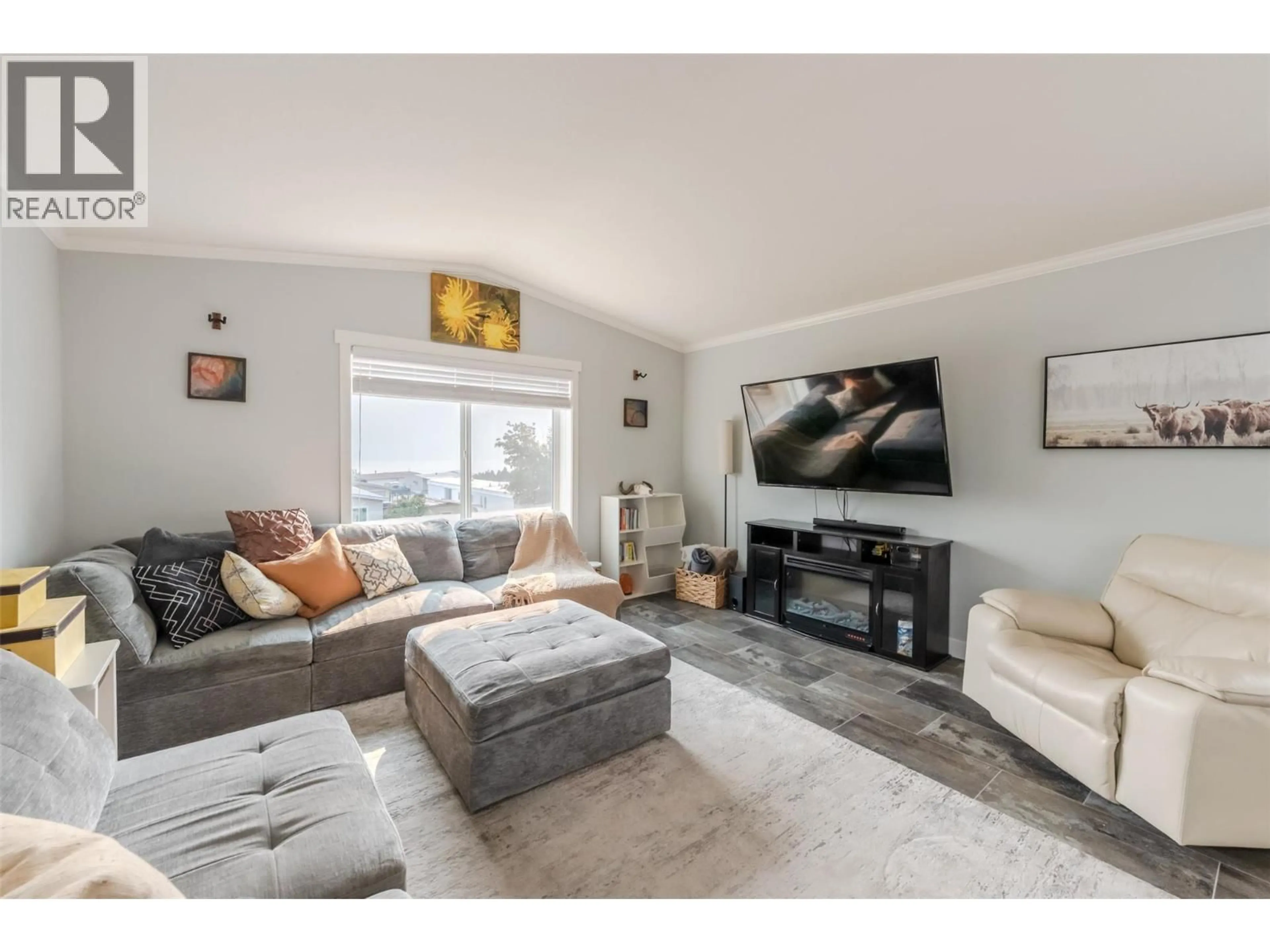 Living room with furniture, wood/laminate floor for 82 - 201 HIGHWAY 97 OTHER, Penticton British Columbia V2A0E4