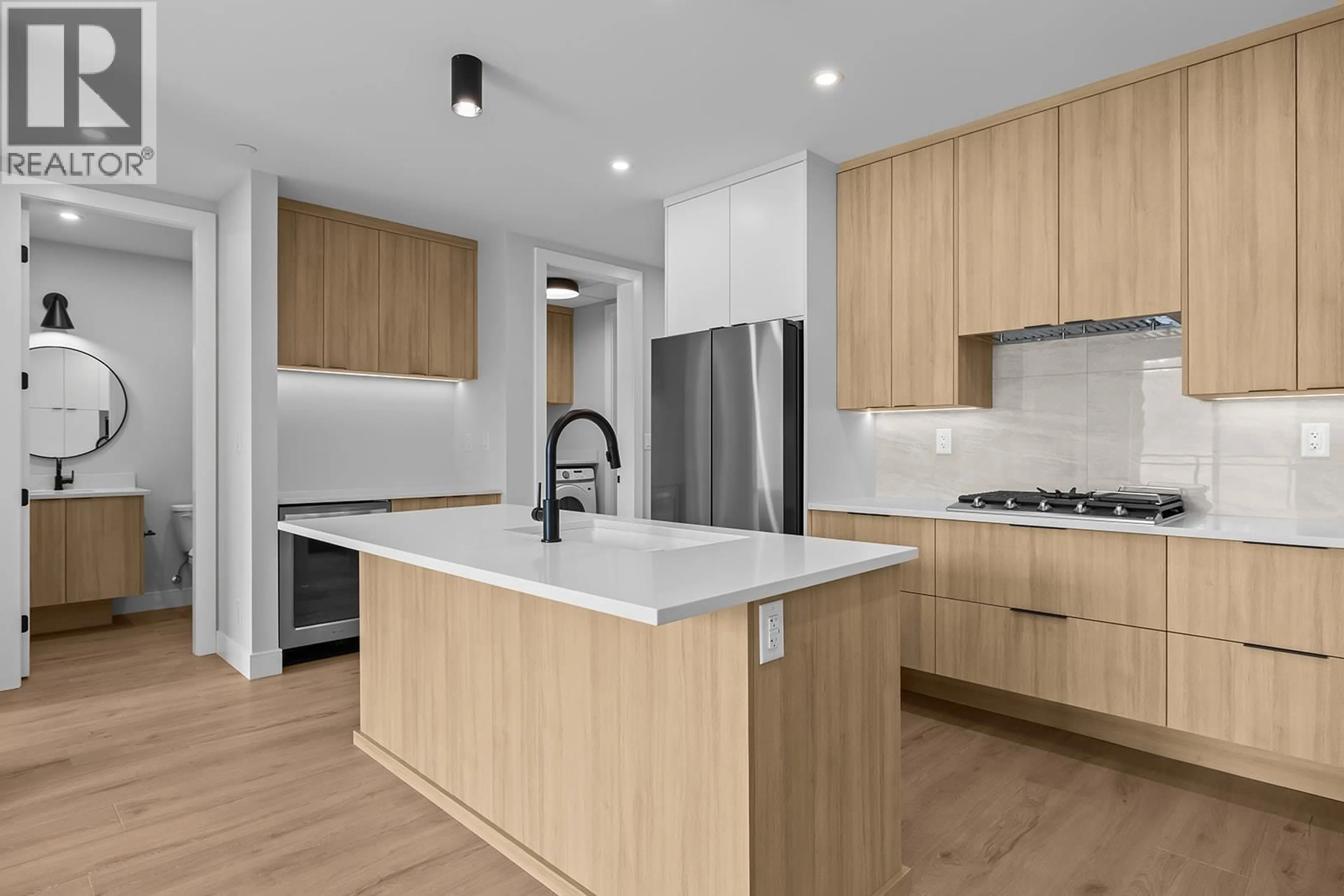 Open concept kitchen, wood/laminate floor for 506 - 75 PREDATOR RIDGE DRIVE, Vernon British Columbia V1H1G4