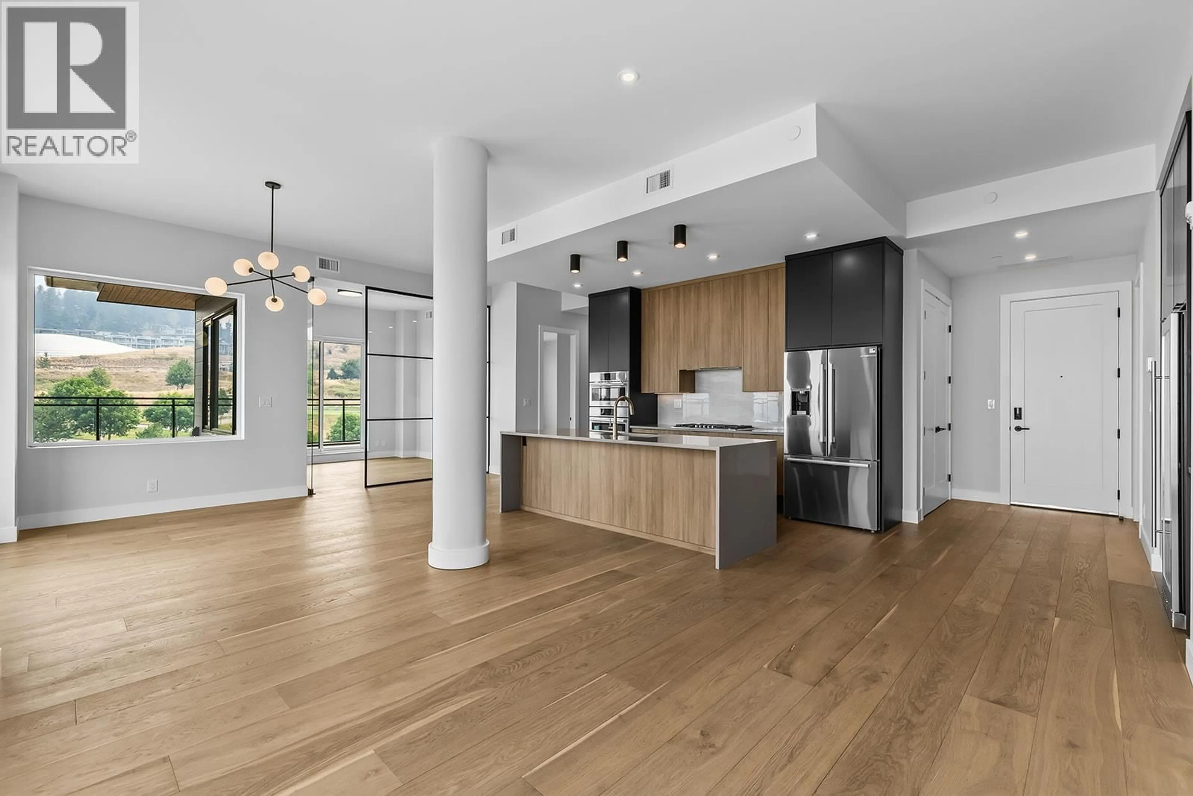 Open concept kitchen, wood/laminate floor for 606 - 75 PREDATOR RIDGE DRIVE, Vernon British Columbia V1H1G4