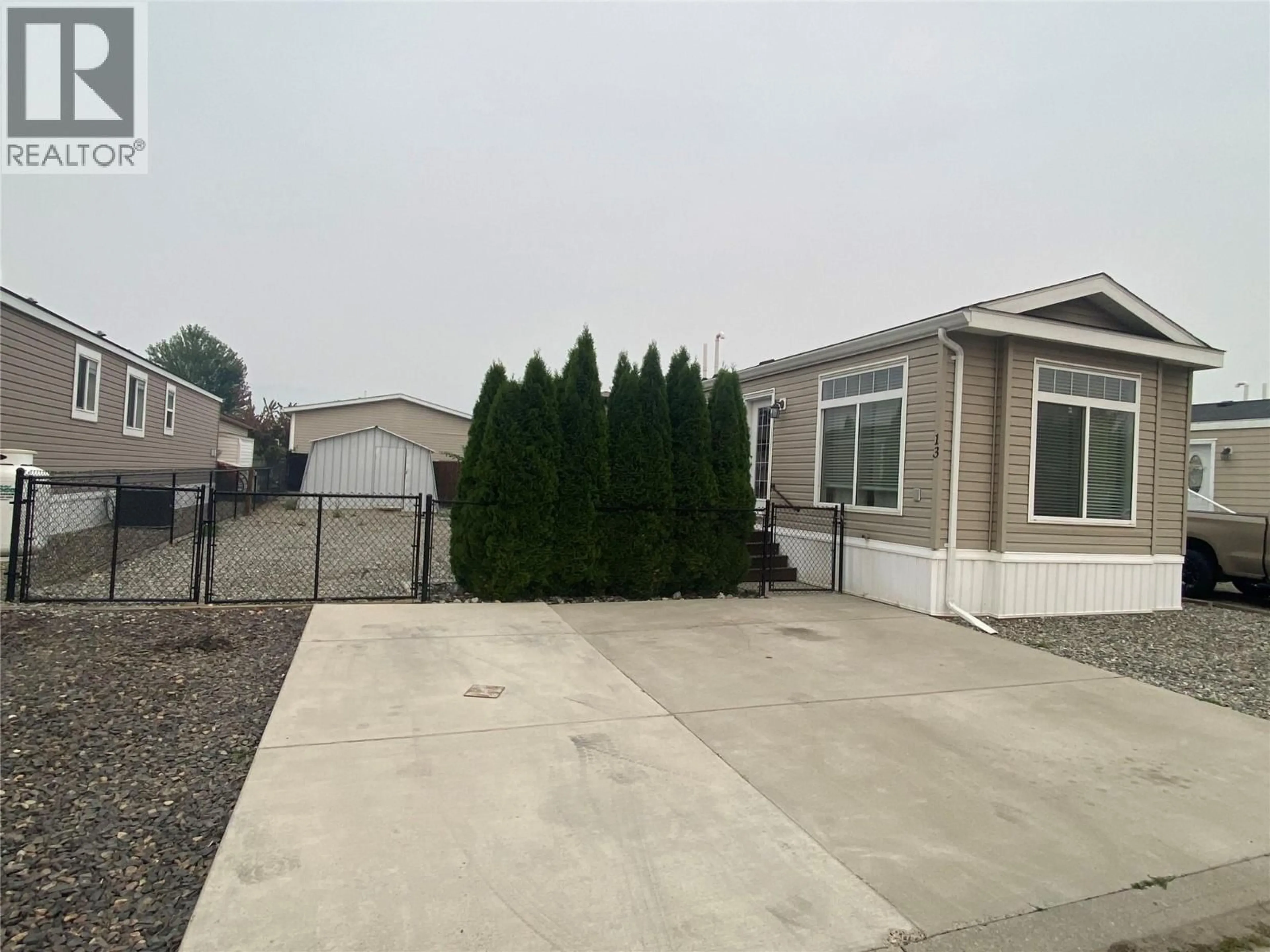 Home with vinyl exterior material, street for 13 - 8945 97 HIGHWAY, Kelowna British Columbia V4V1E8