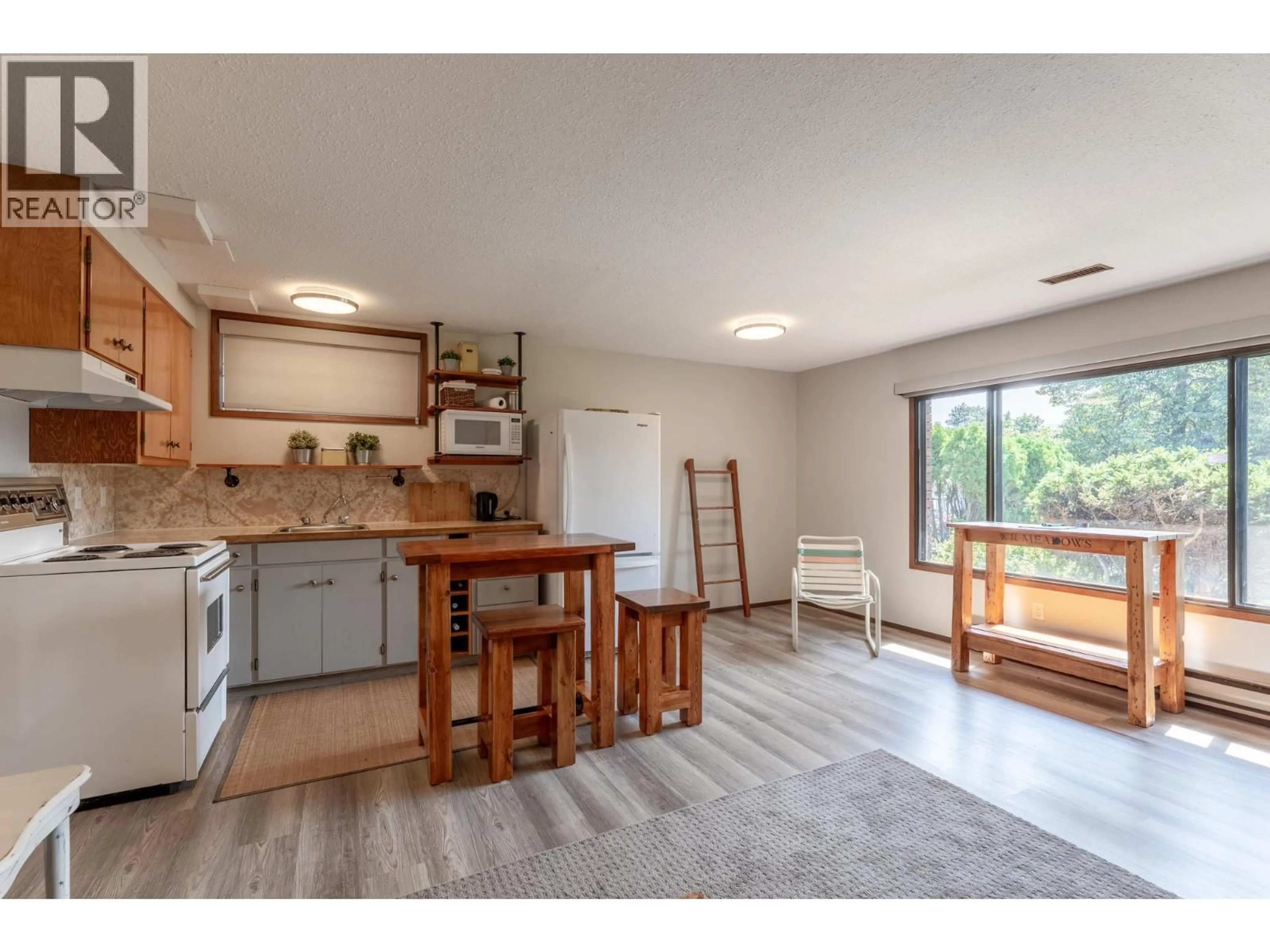 Open concept kitchen, wood/laminate floor for 1470 LAWRENCE AVENUE, Kelowna British Columbia V1Y6M8
