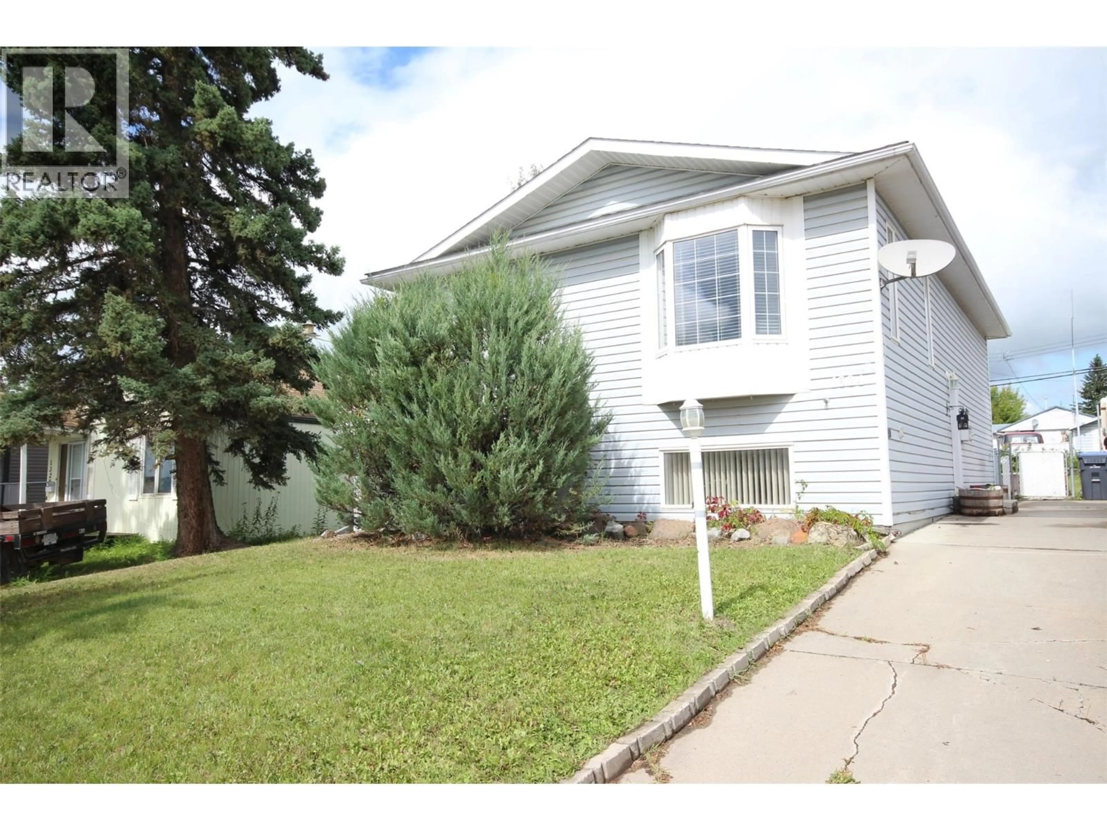 Home with vinyl exterior material, street for 1324 95 AVENUE, Dawson Creek British Columbia V1G1J4