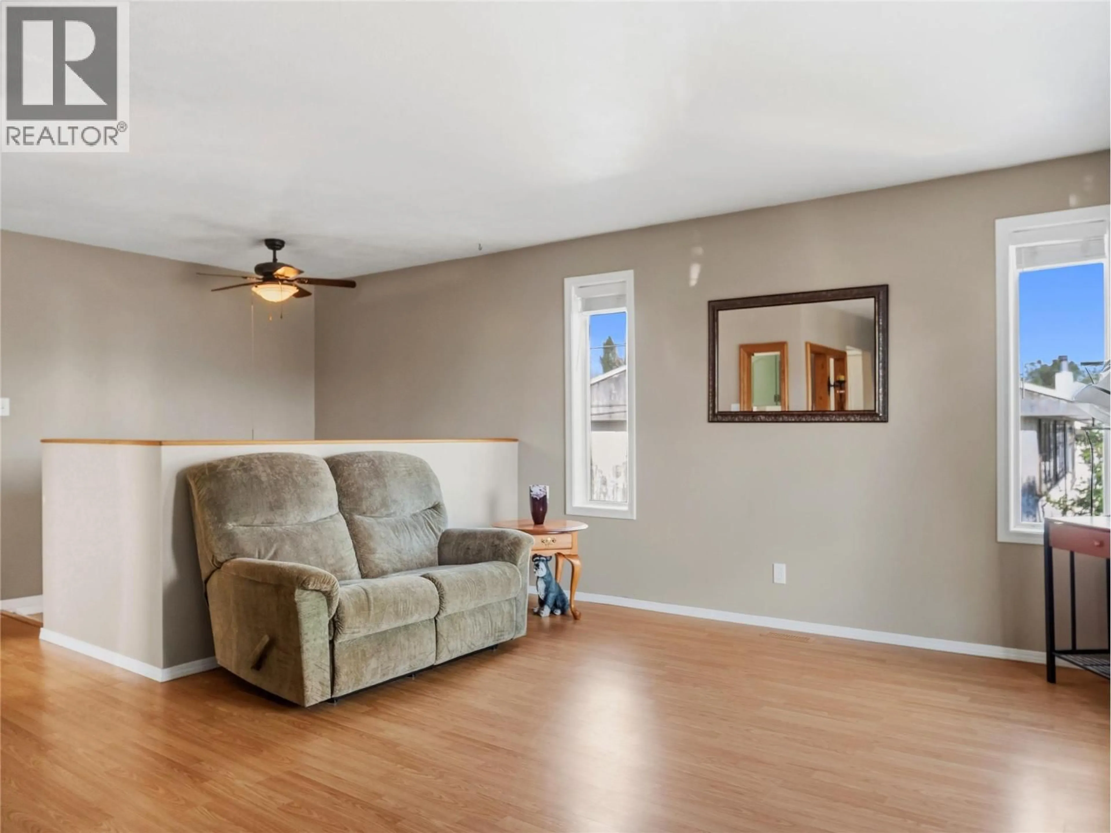 Living room with furniture, wood/laminate floor for 1324 95 AVENUE, Dawson Creek British Columbia V1G1J4