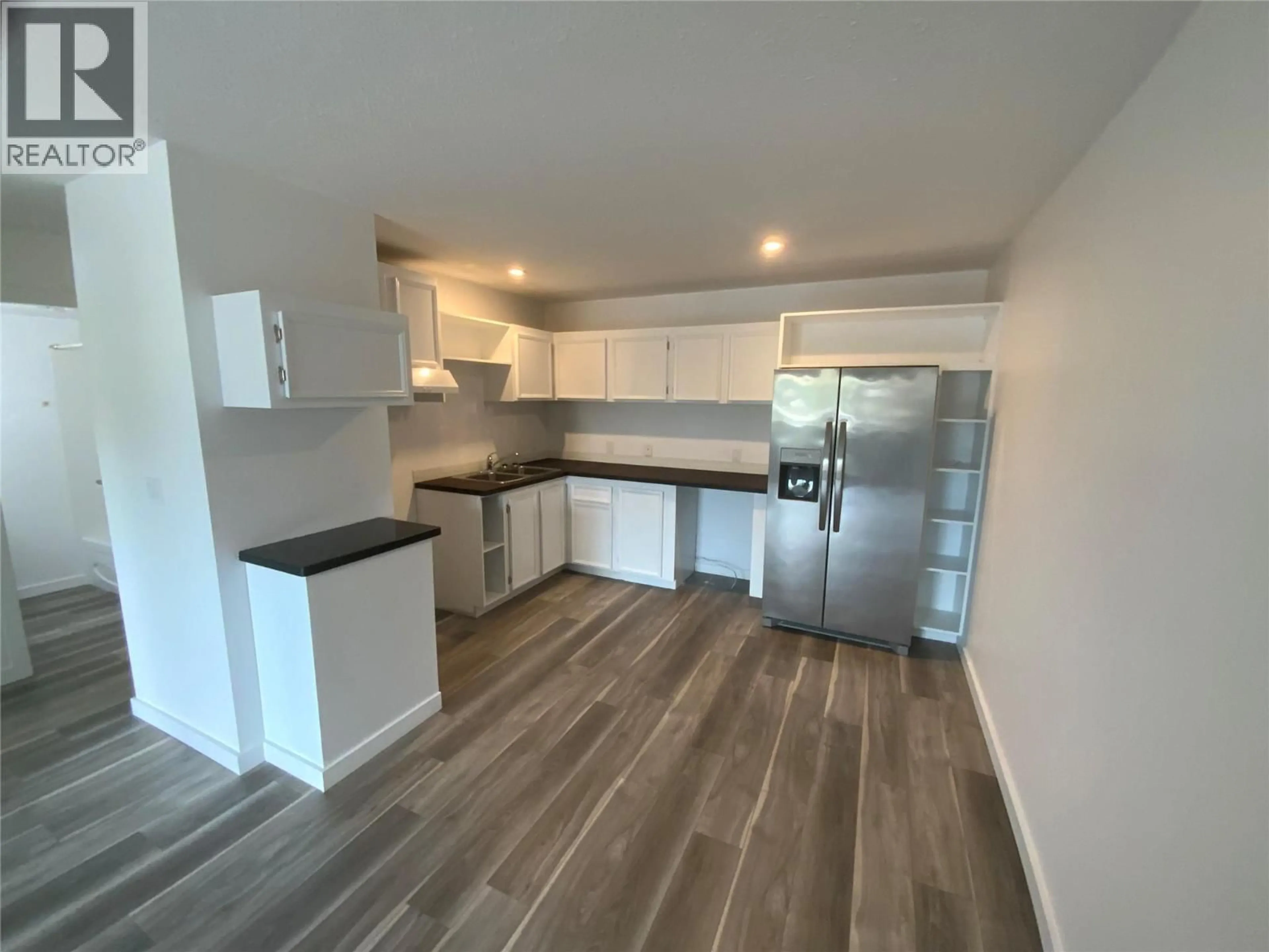 Open concept kitchen, wood/laminate floor for 207 - 150 SKAHA PLACE, Penticton British Columbia V2A7K1