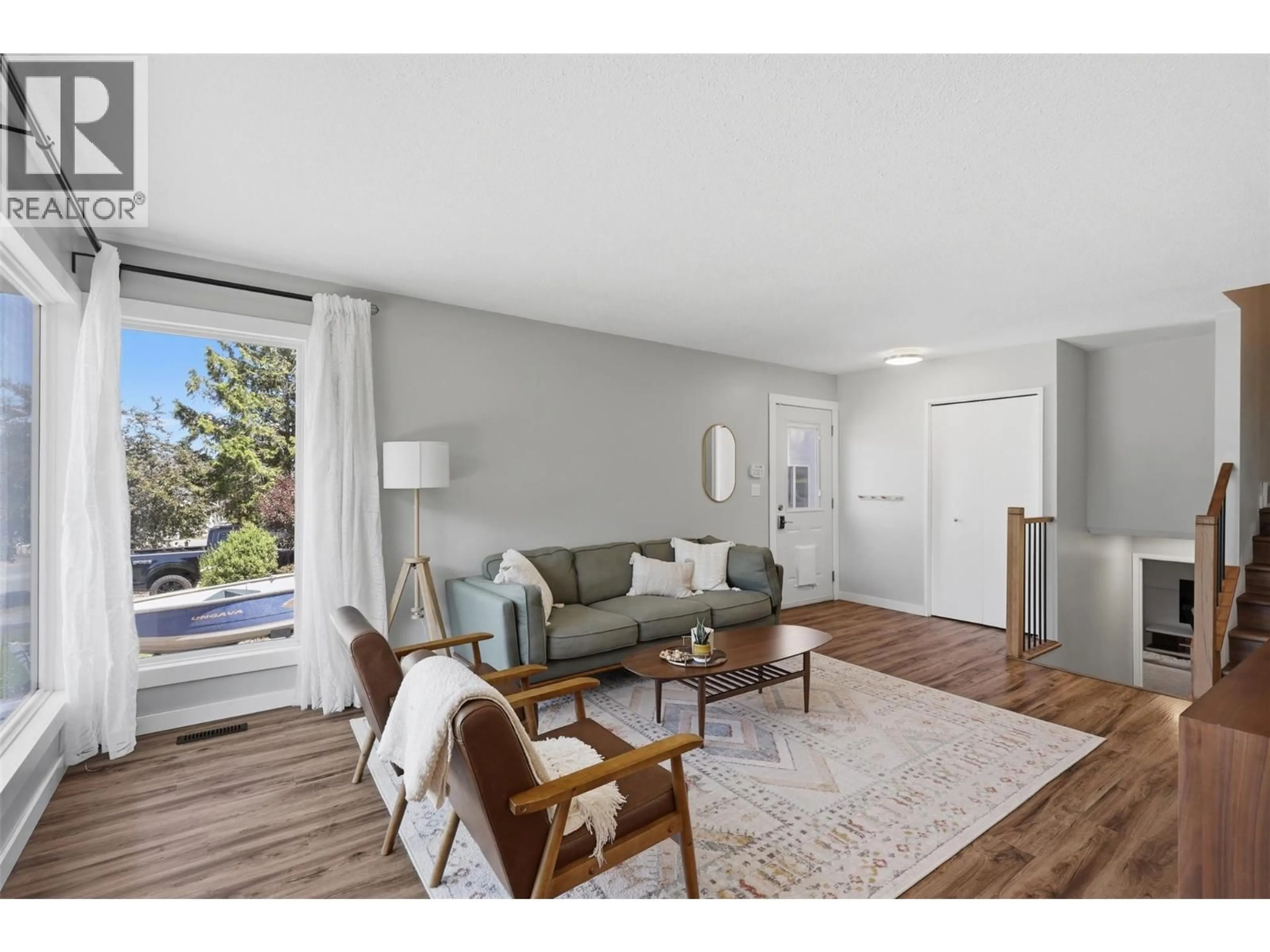 Living room with furniture, wood/laminate floor for 575 GLENEAGLES DRIVE, Kamloops British Columbia V2E1X1