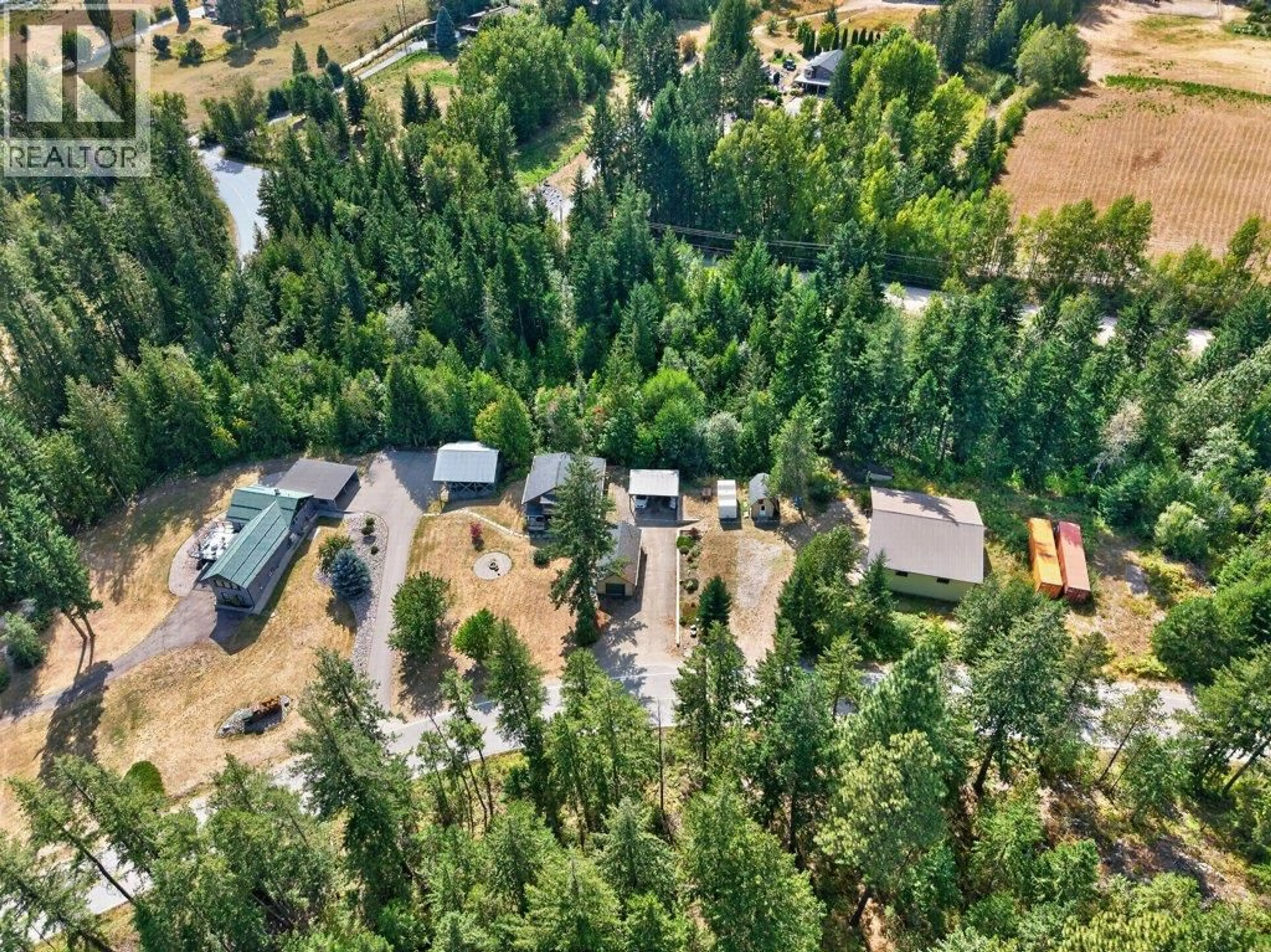 A pic from outside/outdoor area/front of a property/back of a property/a pic from drone, forest/trees view for 411 CHRISTISON ROAD SOUTHWEST, Salmon Arm British Columbia V1E3B4