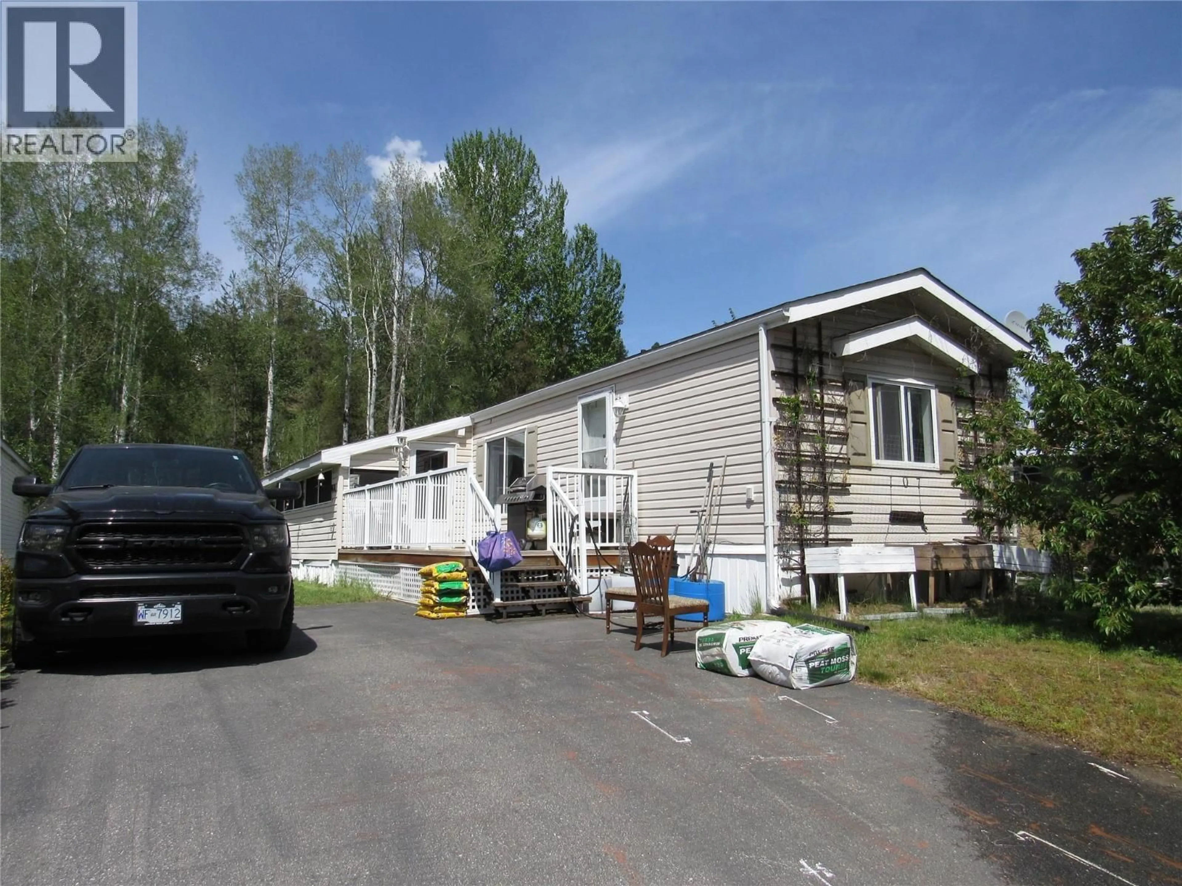 Home with vinyl exterior material, street for 107 - 500 16TH AVENUE, Genelle British Columbia V0G1G0