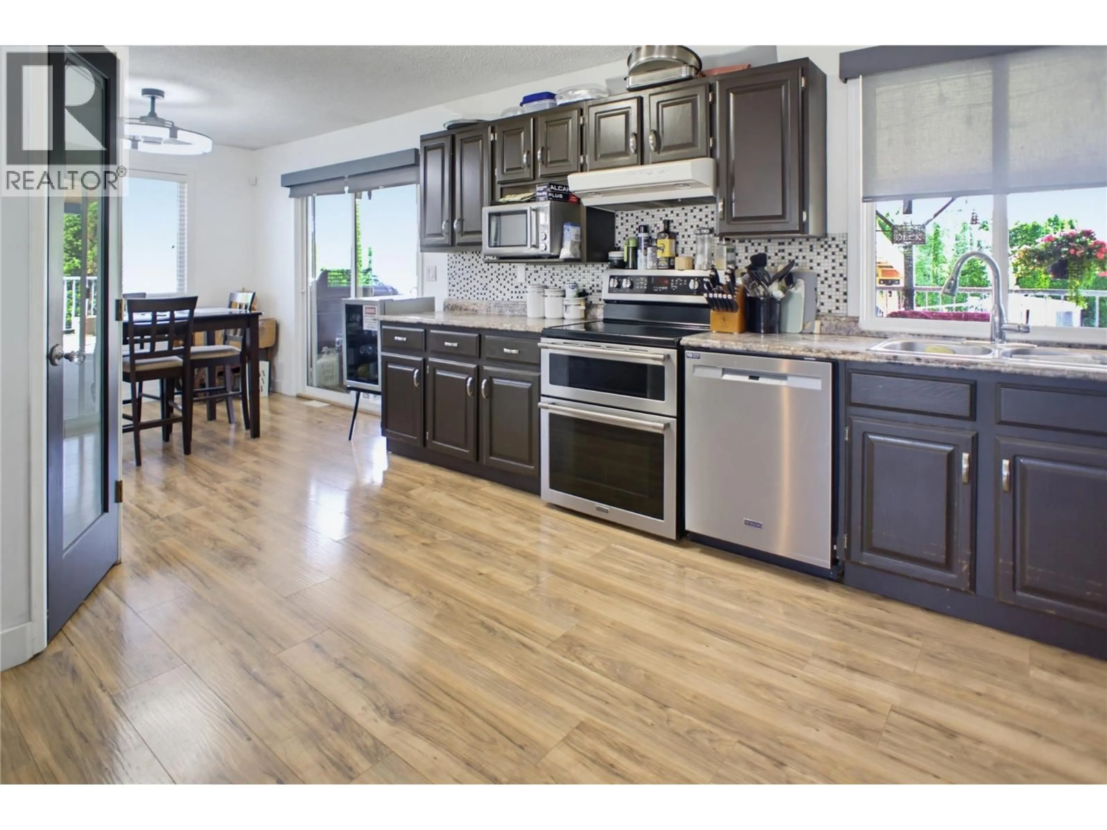 Open concept kitchen, wood/laminate floor for 15 KELSO CRESCENT, Kamloops British Columbia V2C5A1