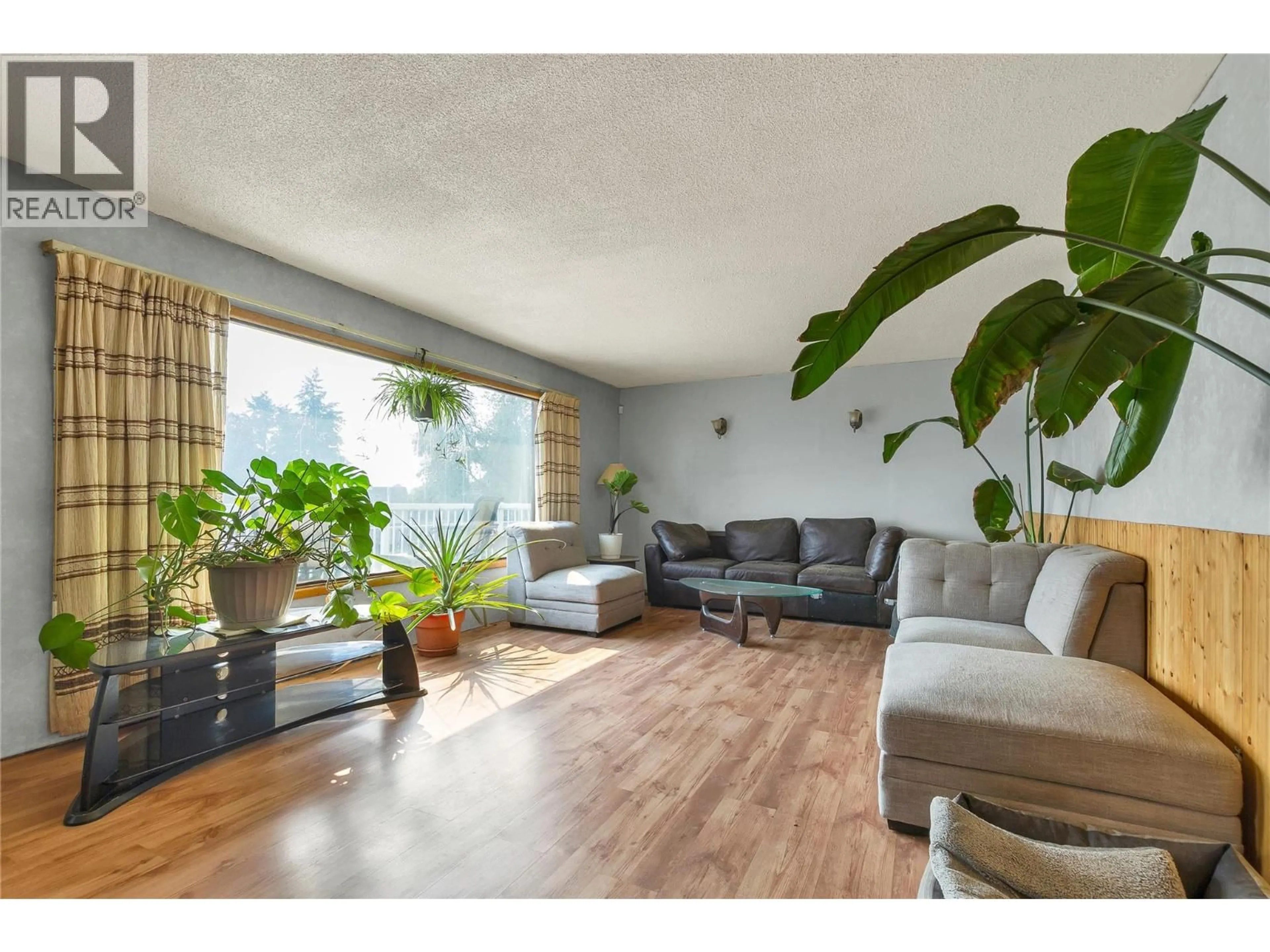 Living room with furniture, wood/laminate floor for 9271 GLENMORE ROAD, Winfield British Columbia V4V1M8
