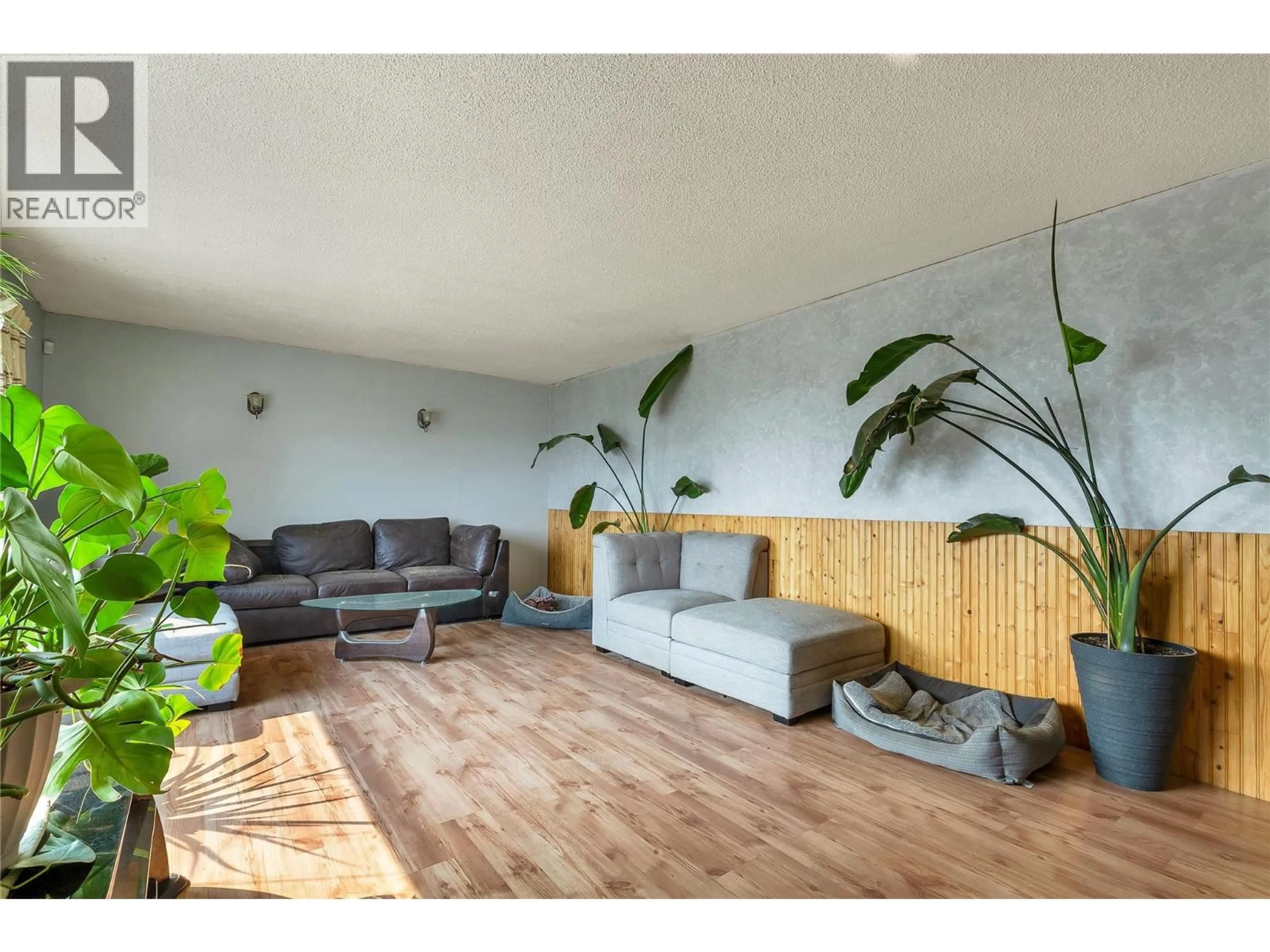 Living room with furniture, wood/laminate floor for 9271 GLENMORE ROAD, Winfield British Columbia V4V1M8