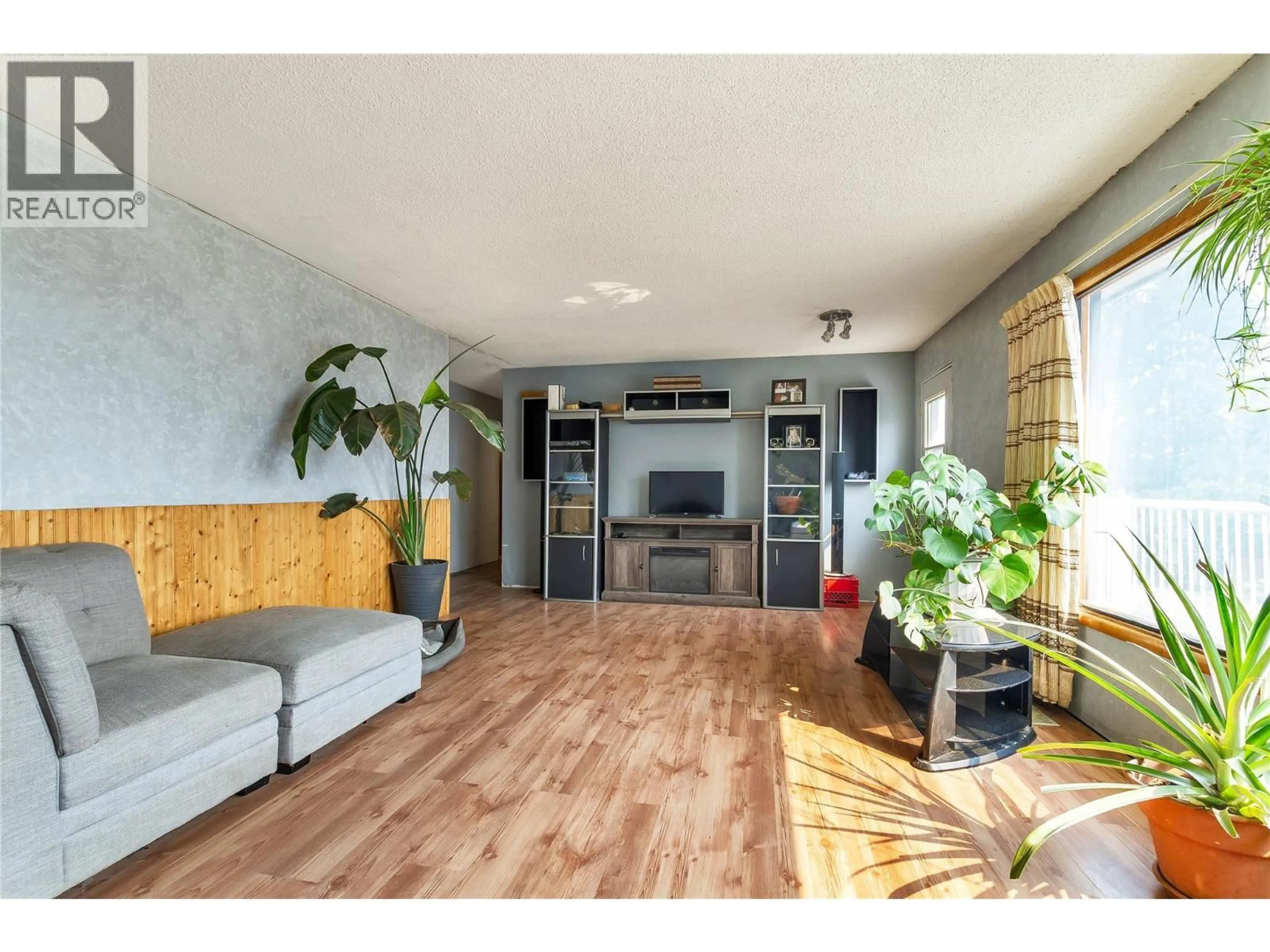 Living room with furniture, wood/laminate floor for 9271 GLENMORE ROAD, Winfield British Columbia V4V1M8
