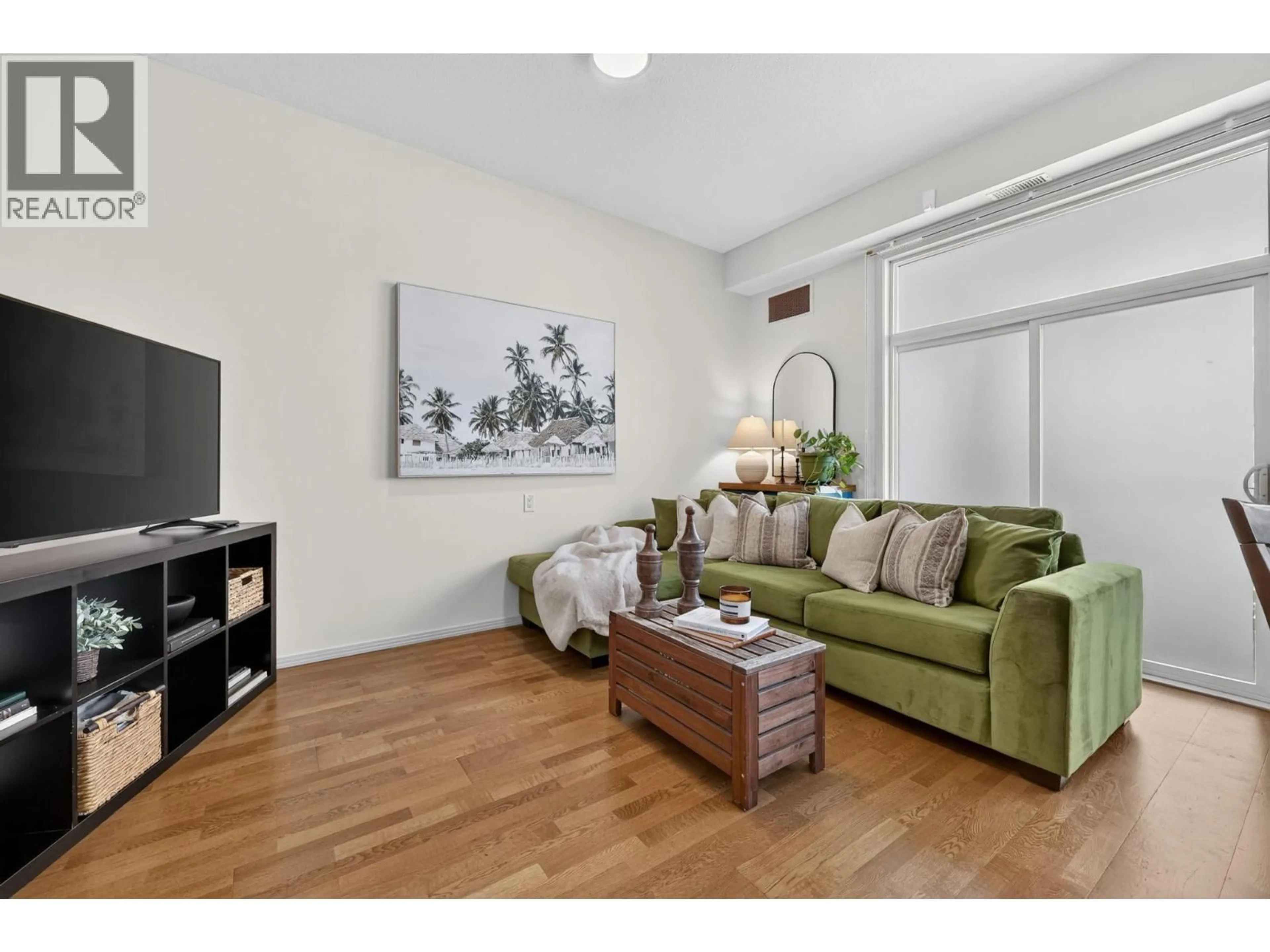 Living room with furniture, wood/laminate floor for 317 - 1331 ELLIS STREET, Kelowna British Columbia V1Y1Z9
