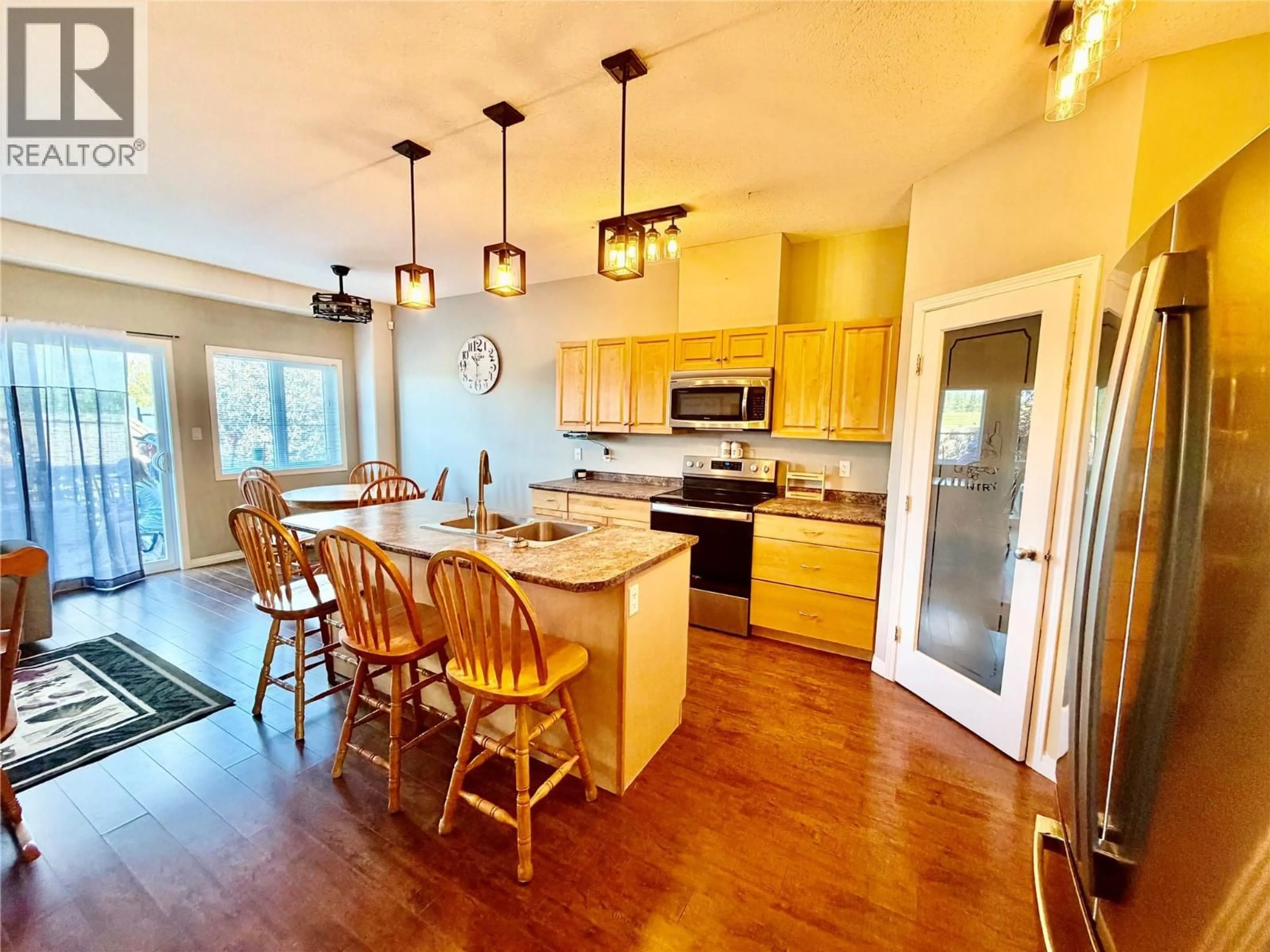 Open concept kitchen, wood/laminate floor for 1556 LORAN DRIVE, Dawson Creek British Columbia V1G1B6
