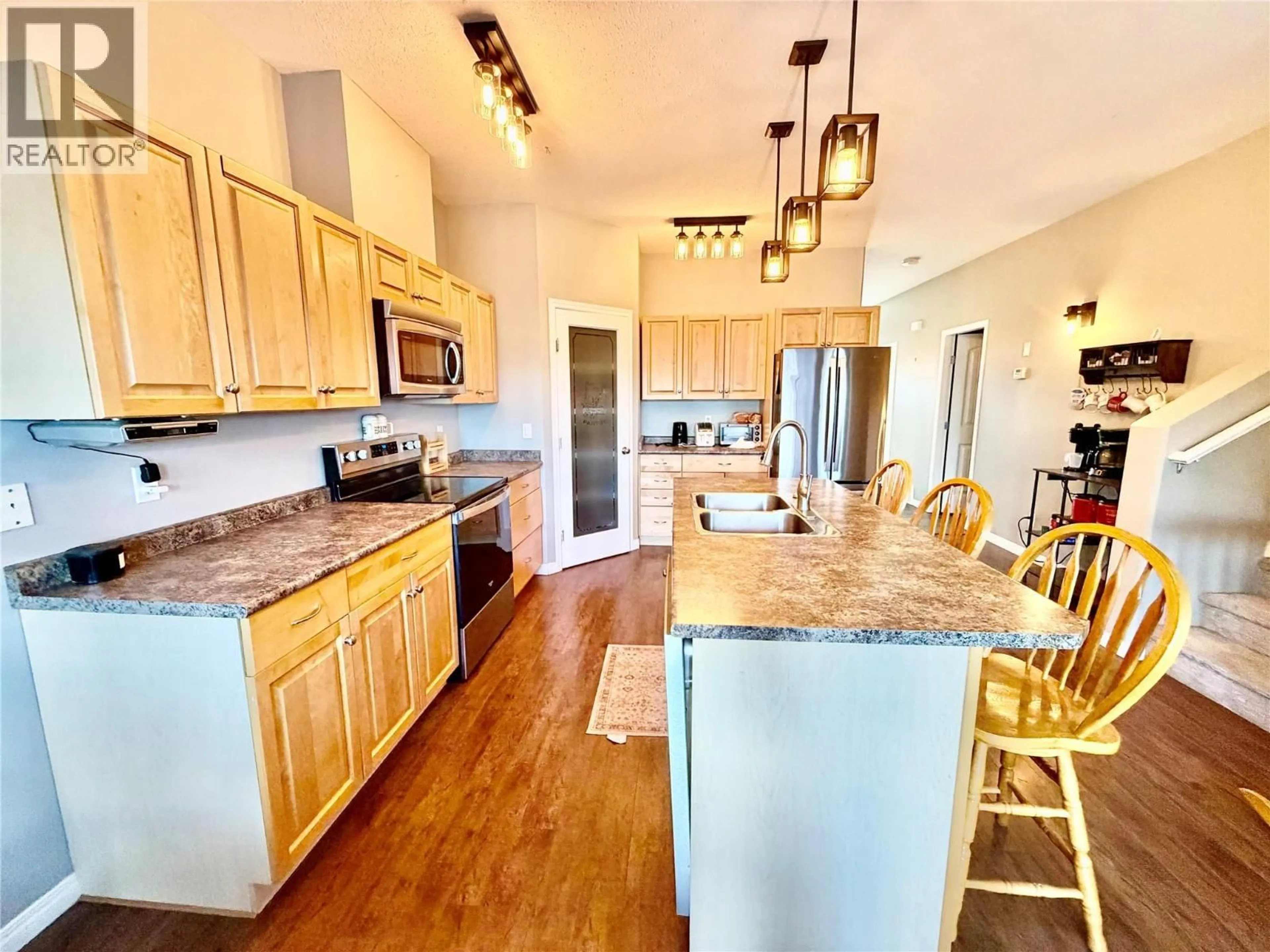 Open concept kitchen, wood/laminate floor for 1556 LORAN DRIVE, Dawson Creek British Columbia V1G1B6